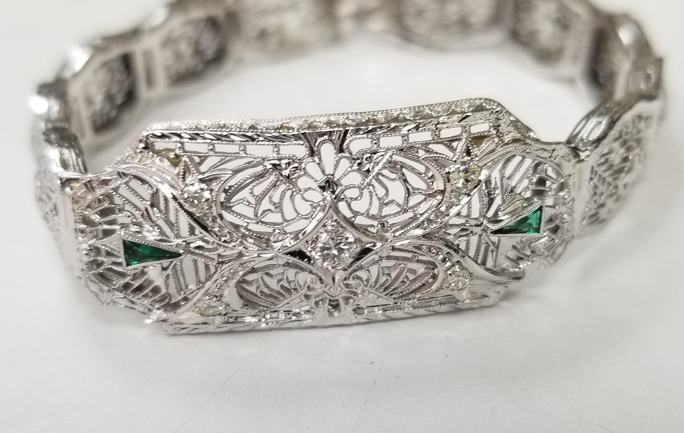 Beautiful women's Art Deco filigree bracelet in 14k white gold. This bracelet features round brilliant cut diamonds and  triangle emeralds.  The bracelet has a solid clasp and safety. 
Specifications:
    main stone: ROUND CUT 
    additional: