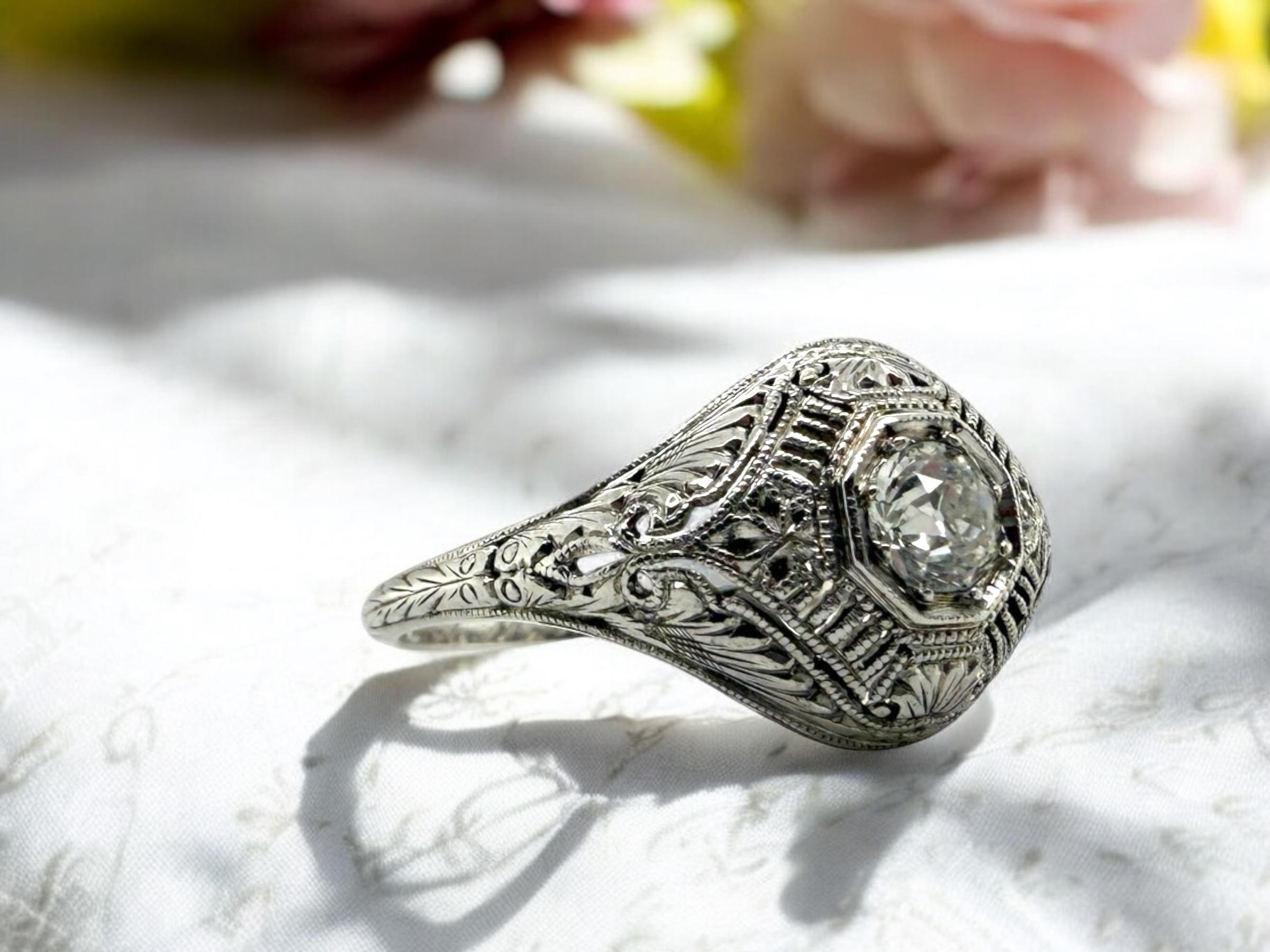 We are loving this vintage beauty!
The filigree work is exceptional!!

Ring Details
Material: 18K White Gold
Era: Art Deco Engraved 1913
Engraved: GLB to ALA 1913
Head Width: 11.5mm
Head Height: 4mm
Shank Width: Tapering to 1.6mm
Weight: 3.2