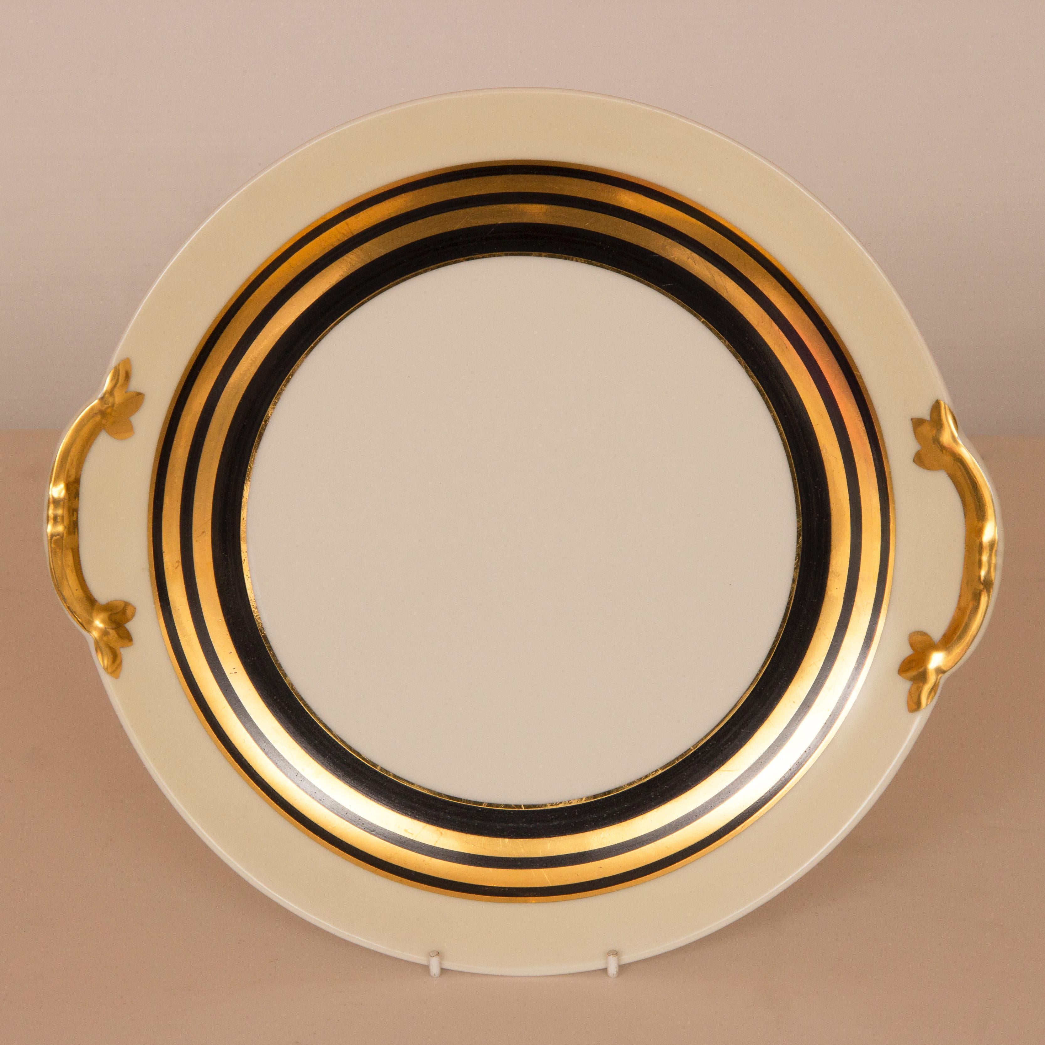 A fine Art Deco tea service in a black and gold wedding band design on a cream ground.
this fine bone china tea set was designed by Charles Ahrenfeldt for Limoges, Charles Ahrenfeldt was the art director at limoges.
Measures: Platter H: 3 cm W: 30