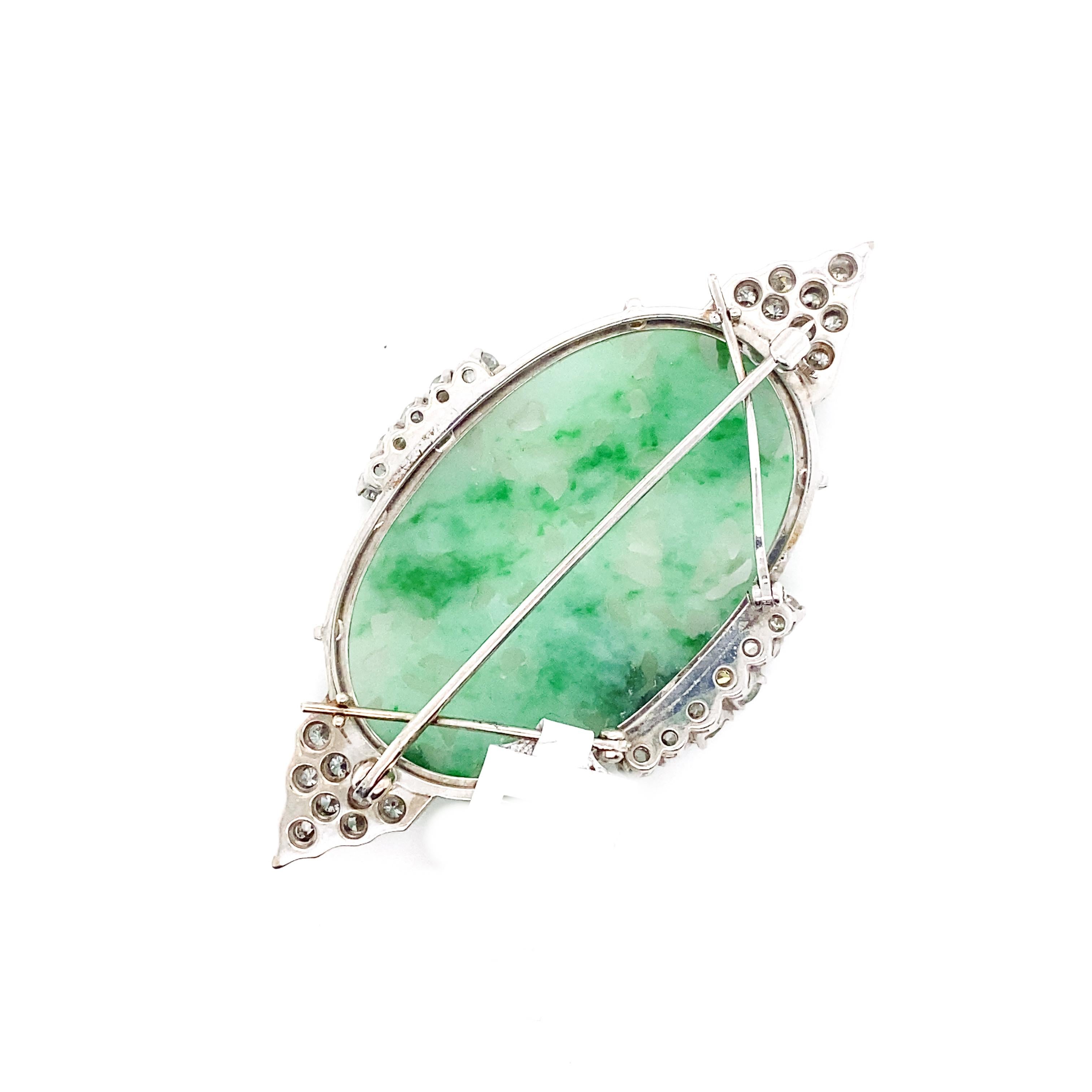 Apart of the wide variety of unique jade pieces for sale. This jade brooch has an intricate design carved into it, with swans carved in with floral patterns surrounding them. Its border has 4 pads for diamonds giving an extra sparkle to this piece,