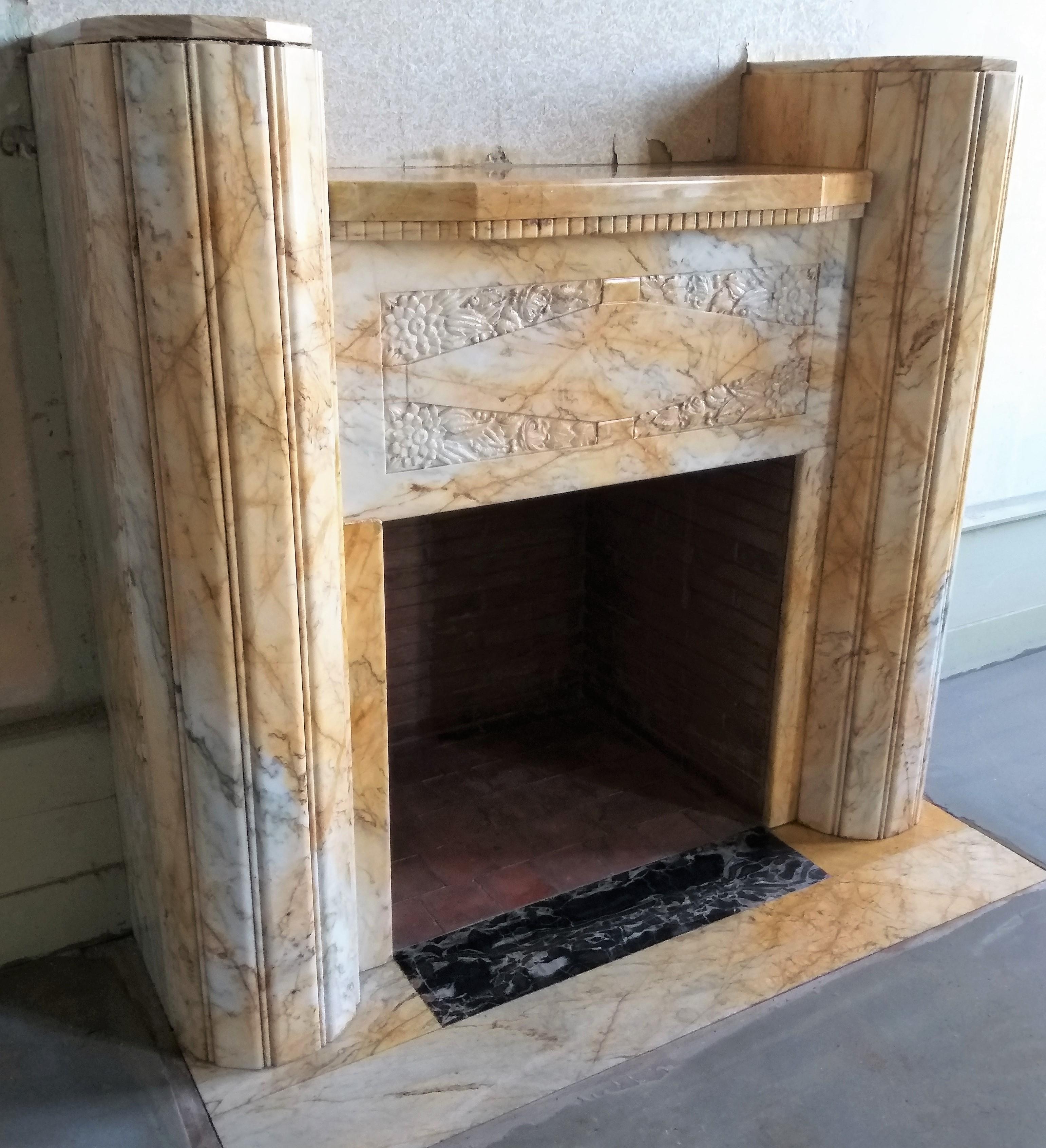 This is a very delicate, colorful and classy Art Deco fireplace, made out of the highly valued marble 'Jaune de Sienne'.
Arte Deco (1920-1939 'The Rouring Twenties') is characterized by color, geometric figures, zig-zag lines and stylized forms.