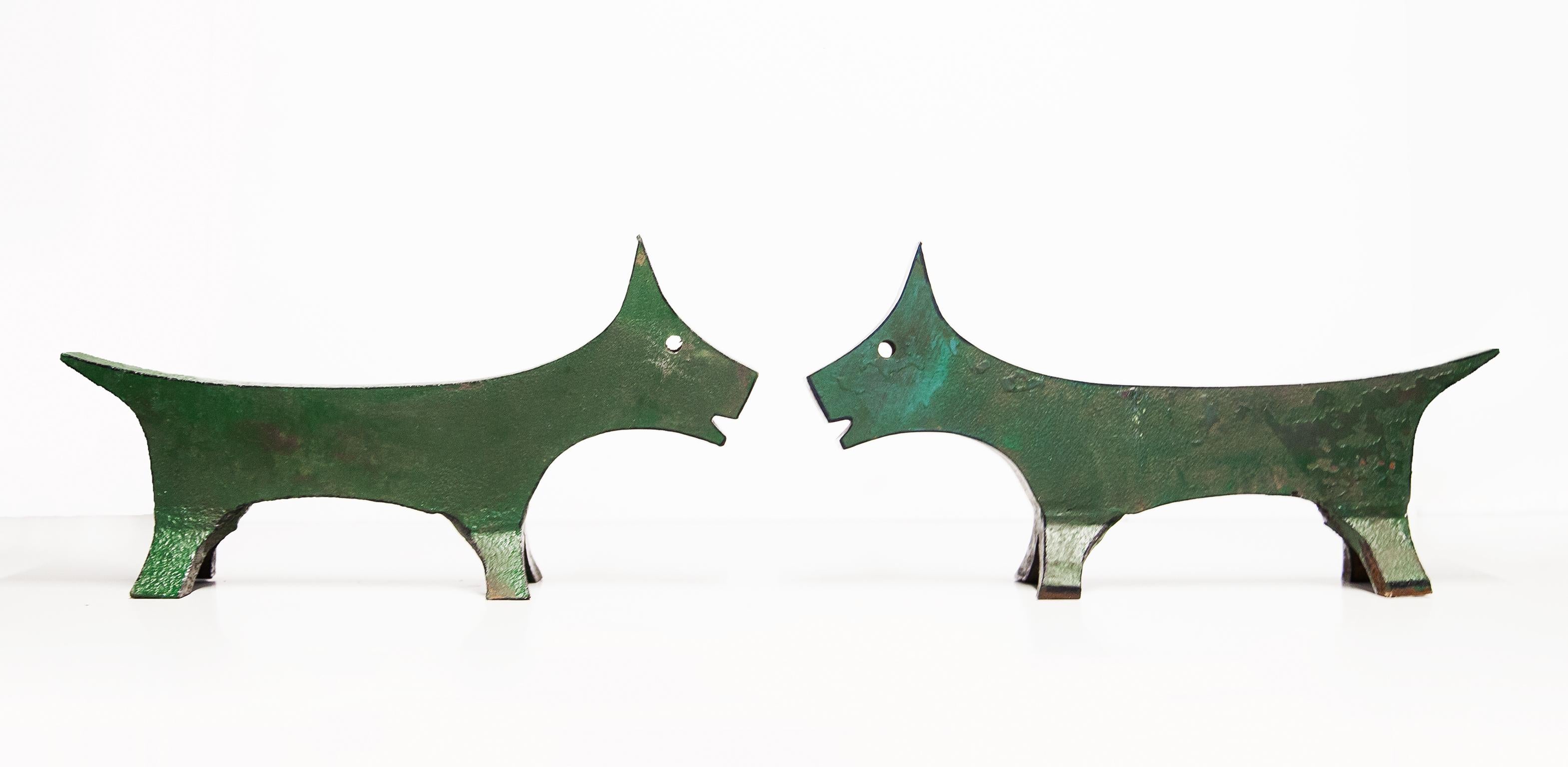 Wonderful set of two dog andirons in solid green painted iron. They were used in a film of Pedro Almodovar.
