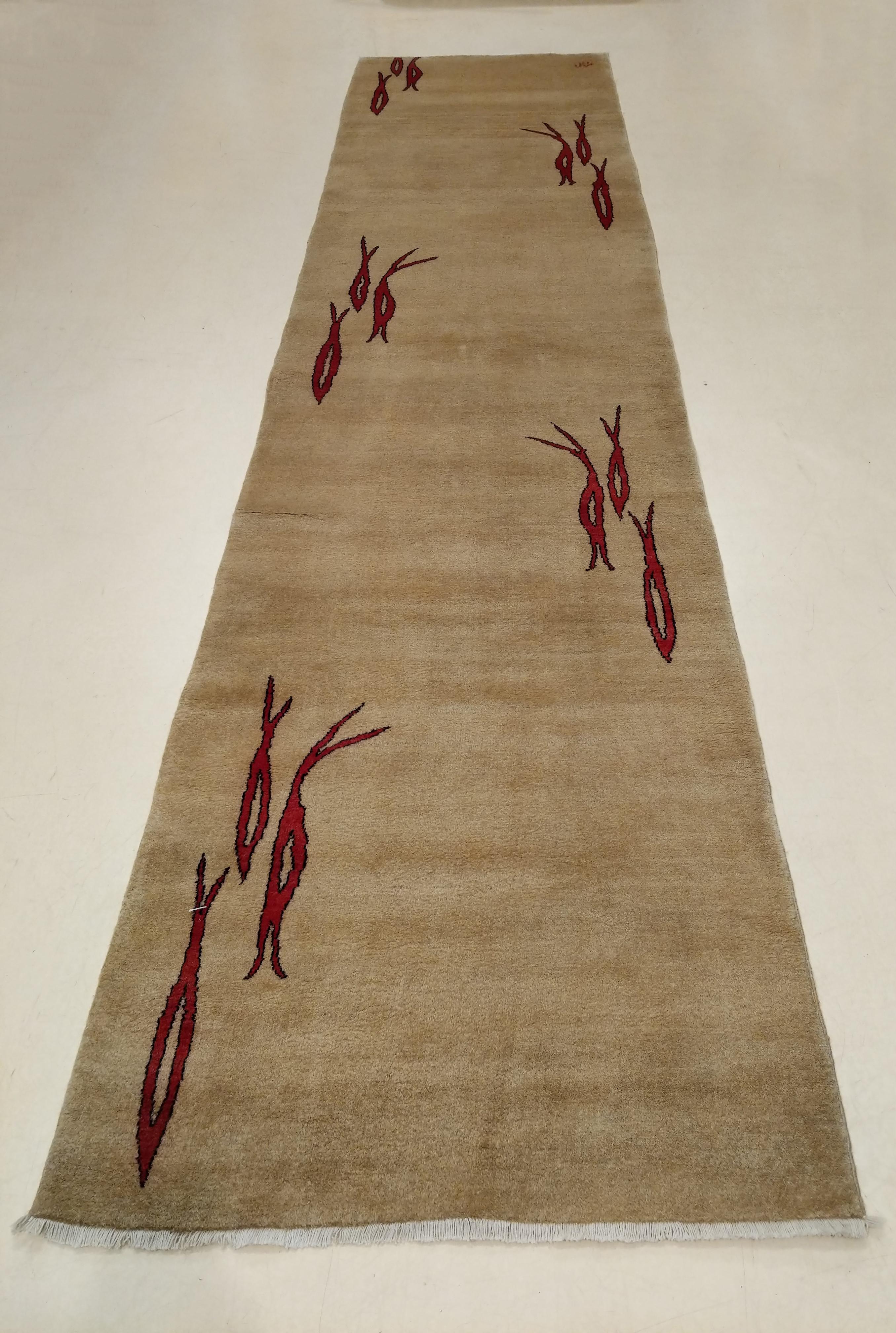 A rare and unique modernist oriental rug, distinguished by an ivory open field partially embellished by groups of three stylized fish in a rich burgundy red. The arrangement of these clusters of fish is strongly reminiscent of the design arrangement