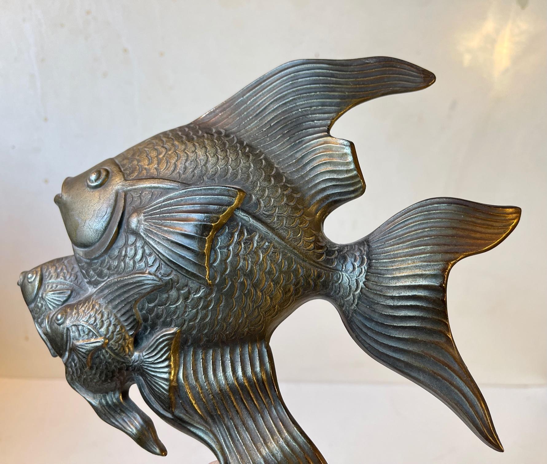 A rather symbiotically conceived cast of a family of fish. Its cast in an alloy of diffrent metals (copper, pewter and brass). It was made in Denmark, Germany or Austria during the 1930s. Its signed indistinguishable to its back. Measurements: H: