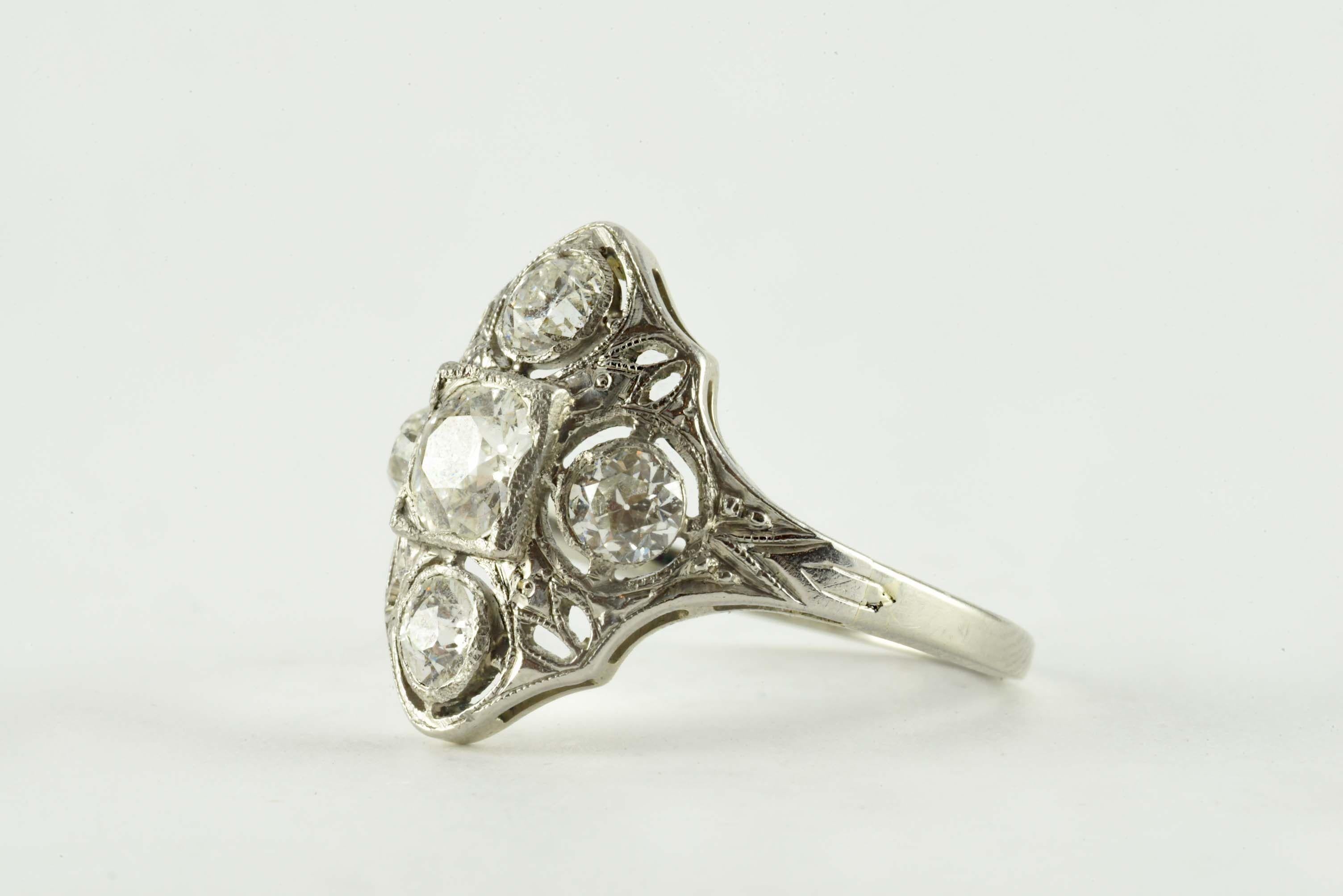 Crafted in the 1920s from platinum, this stunning Navette band is set with an Old European cut diamond center stone measuring 0.47 carats, F-G color, VS clarity and accented on all sides with four Old European cut diamonds totaling approximately