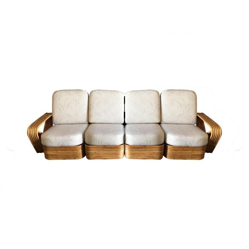 Five-strand square pretzel style, Four-seat sectional sofa. This sofa features the famous six-strand square pretzel side arms and stacked rattan base originally designed by Paul Frankl. The seats are covered in palm leaf pattern barkcloth
