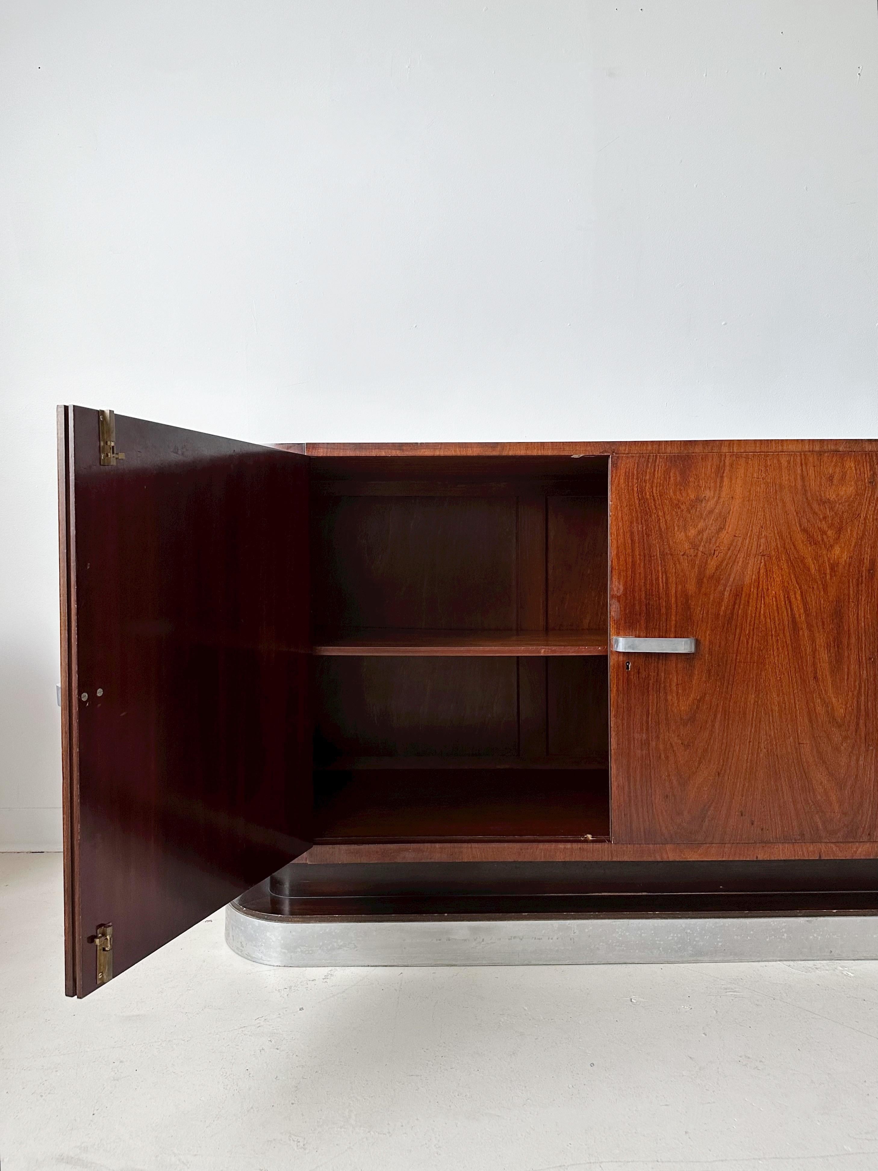 Art Deco Flame Mahogany Credenza with Aluminum Base & Accents In Good Condition For Sale In Outremont, QC