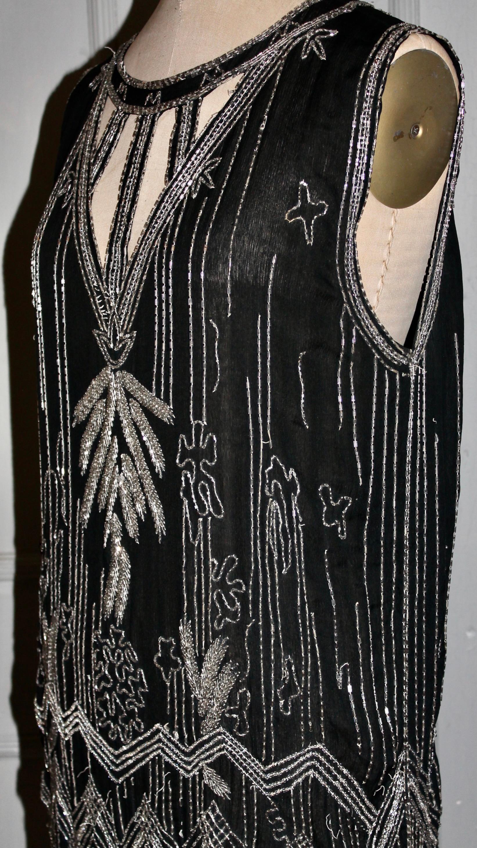 Offering an Extraordinary Art Deco 1920's Couture Black Silk Crepe Beaded 'Flapper' Cocktail Dress. With extreme deco scalloped hem.