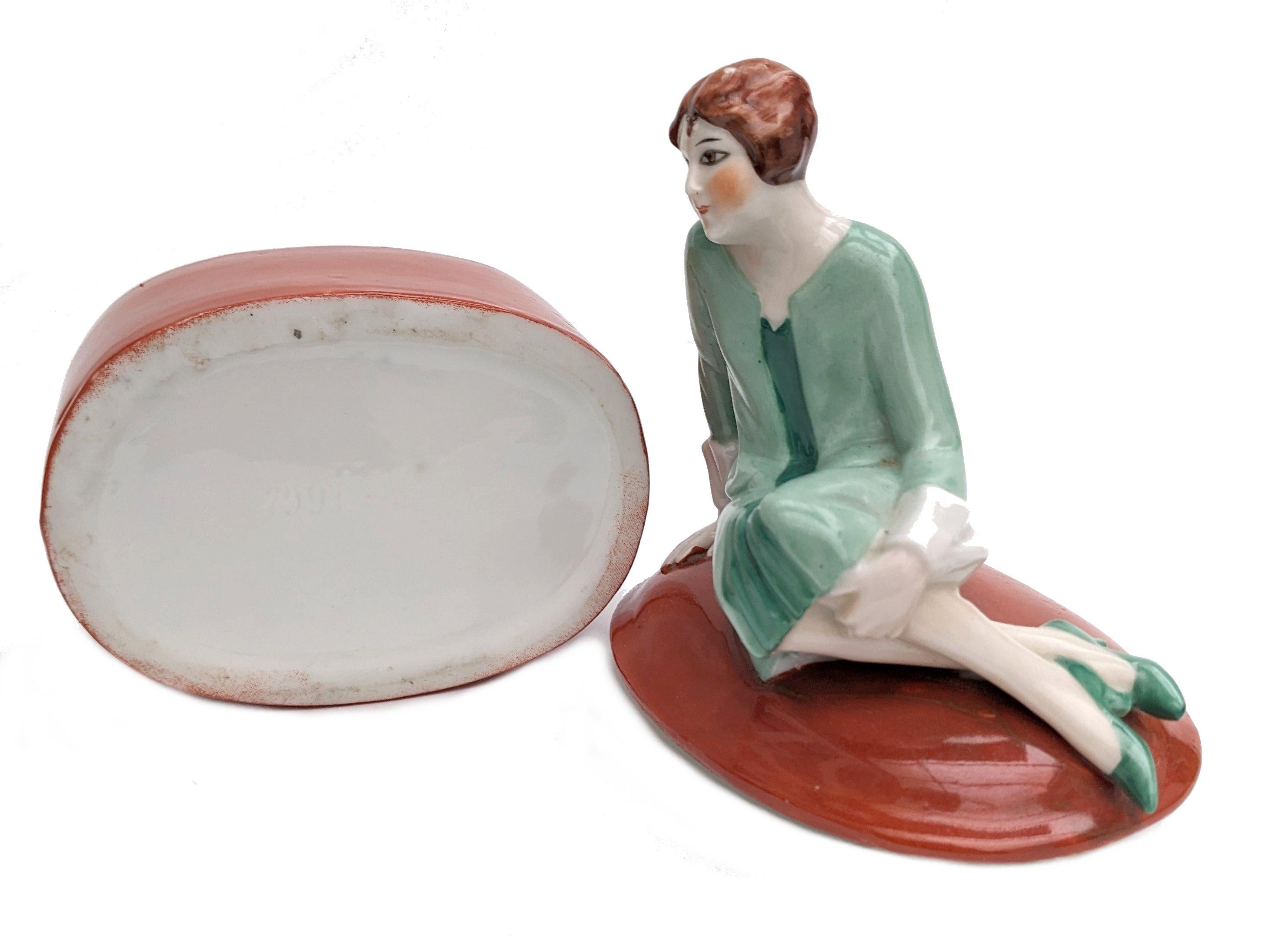 Wonderful 1930's Art Deco ceramic powder box. A rare design and highly sought after. The attention to detail is just wonderful, so skillfully painted, from her slightly blushed cheeks to her tiny fingers, everything about this piece screams quality