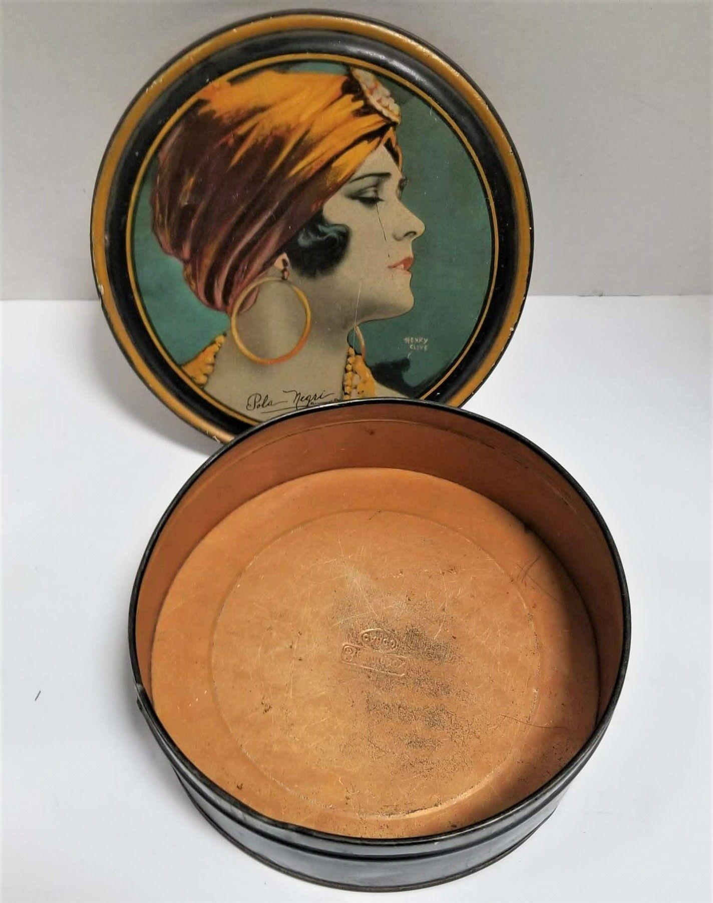 Metal makeup box featuring a portrait by Henry Clive of Paramount Pictures Flapper Pola Negri dressed in her Gypsy Blood film costume.
The bottom reads 