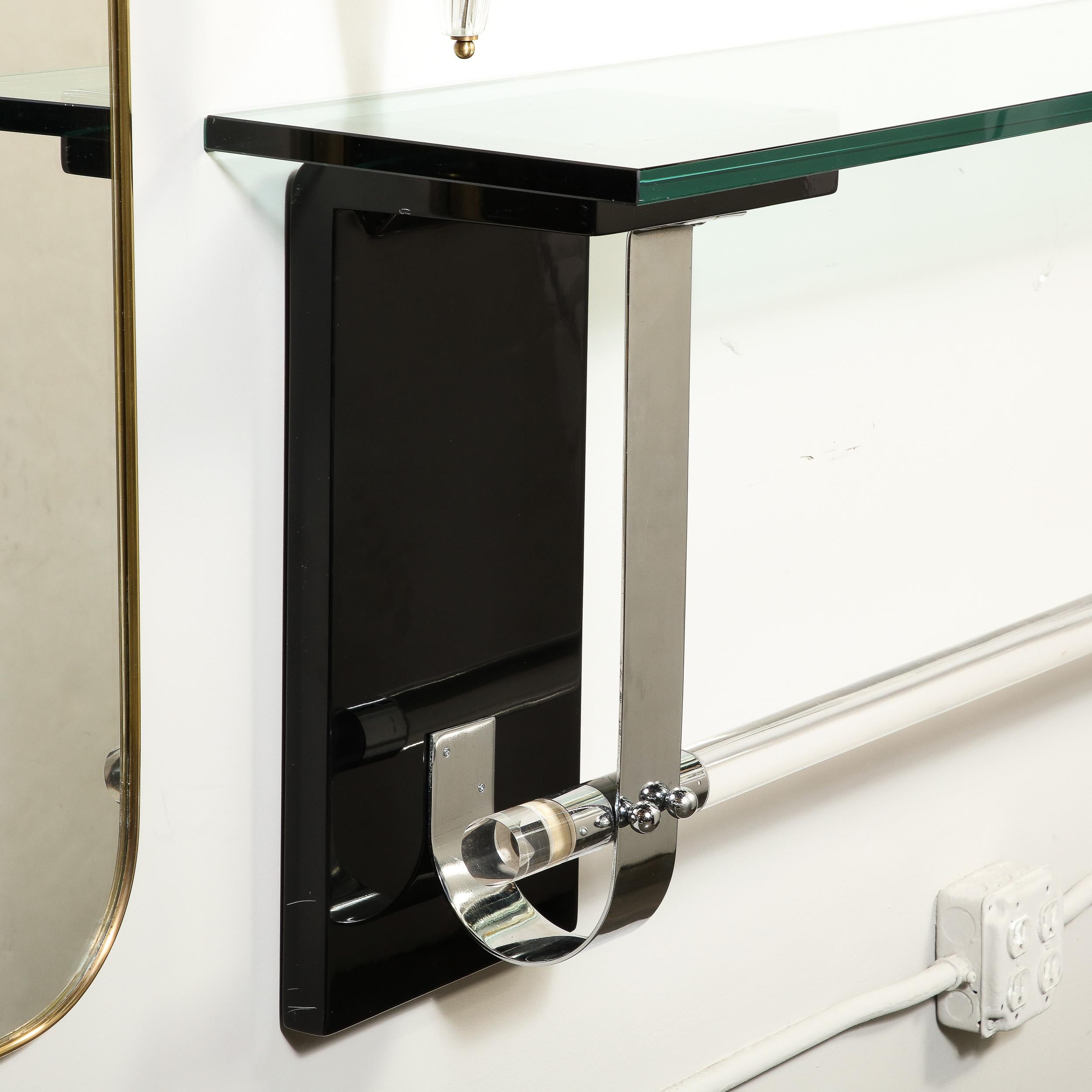 This Art Deco Floating Glass Topped Console shelf  in Black Lacquer originates from the United States Circa 1935. Featuring a substantial glass top, this piece mounts on the wall and can be installed at a variety of heights depending on the demands