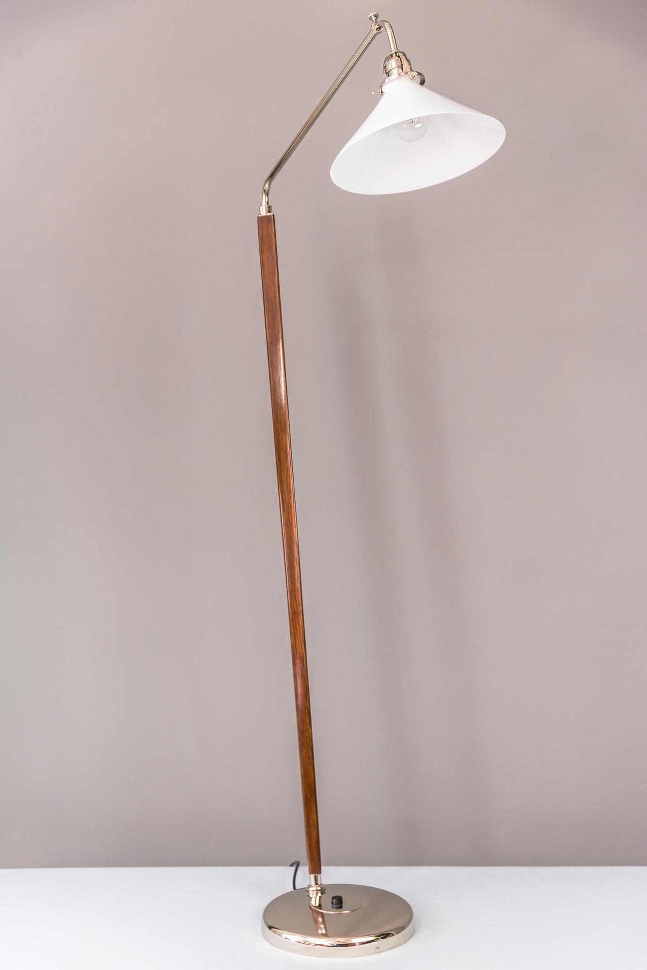 Art Deco floor lamp circa 1930s.
Polished wood.
Original opal glass shade (swiveling).