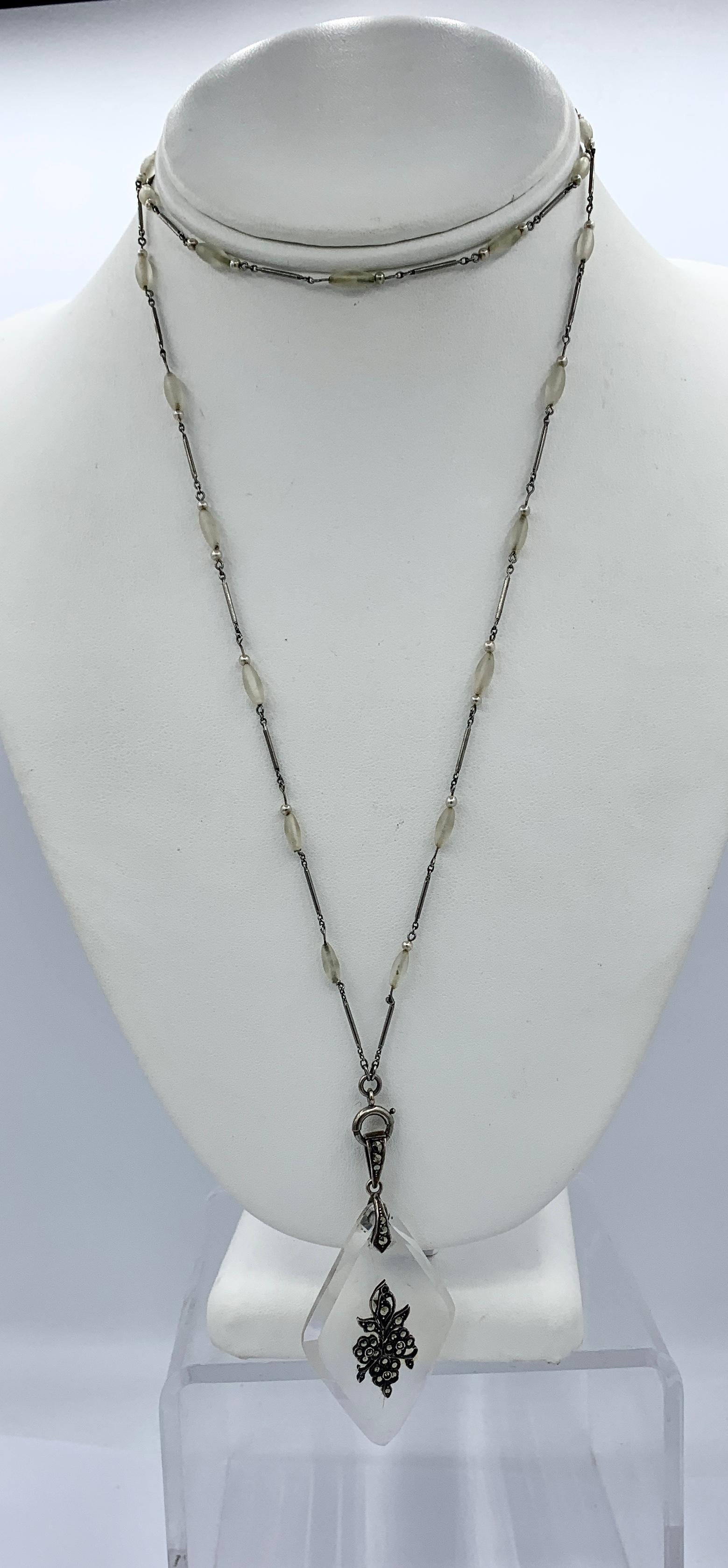 THIS IS A WONDERFUL AND VERY RARE MUSEUM QUALITY ORIGINAL ART DECO PENDANT NECKLACE WITH AN EXTRAORDINARY FLOWER MOTIF ROCK CRYSTAL PENDANT SET WITH STERLING SILVER AND MARCASITES IN A STERLING SILVER SURMOUNT WITH A MARCASITE SET BALE.  THE PENDANT