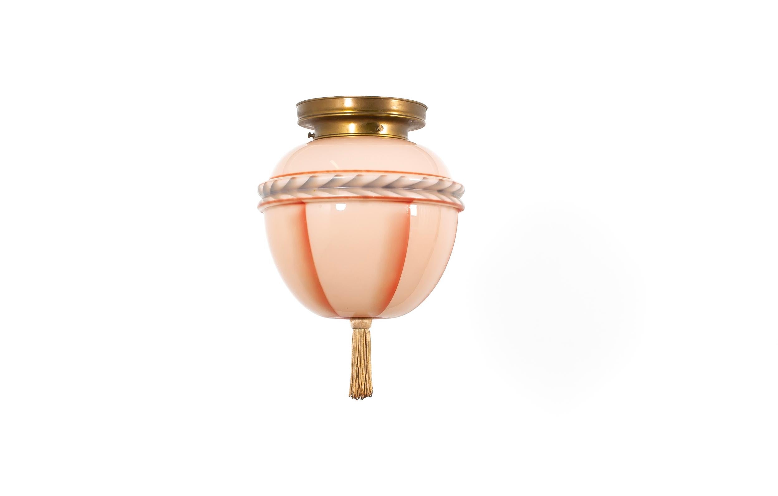 Rare and charming ceiling light fixture, designed and made in Norway during the late 1930s. The fixture features a hand-painted glass shade with soft pastel tones, elegantly mounted on a polished brass holder with a textile tassel hanging from the