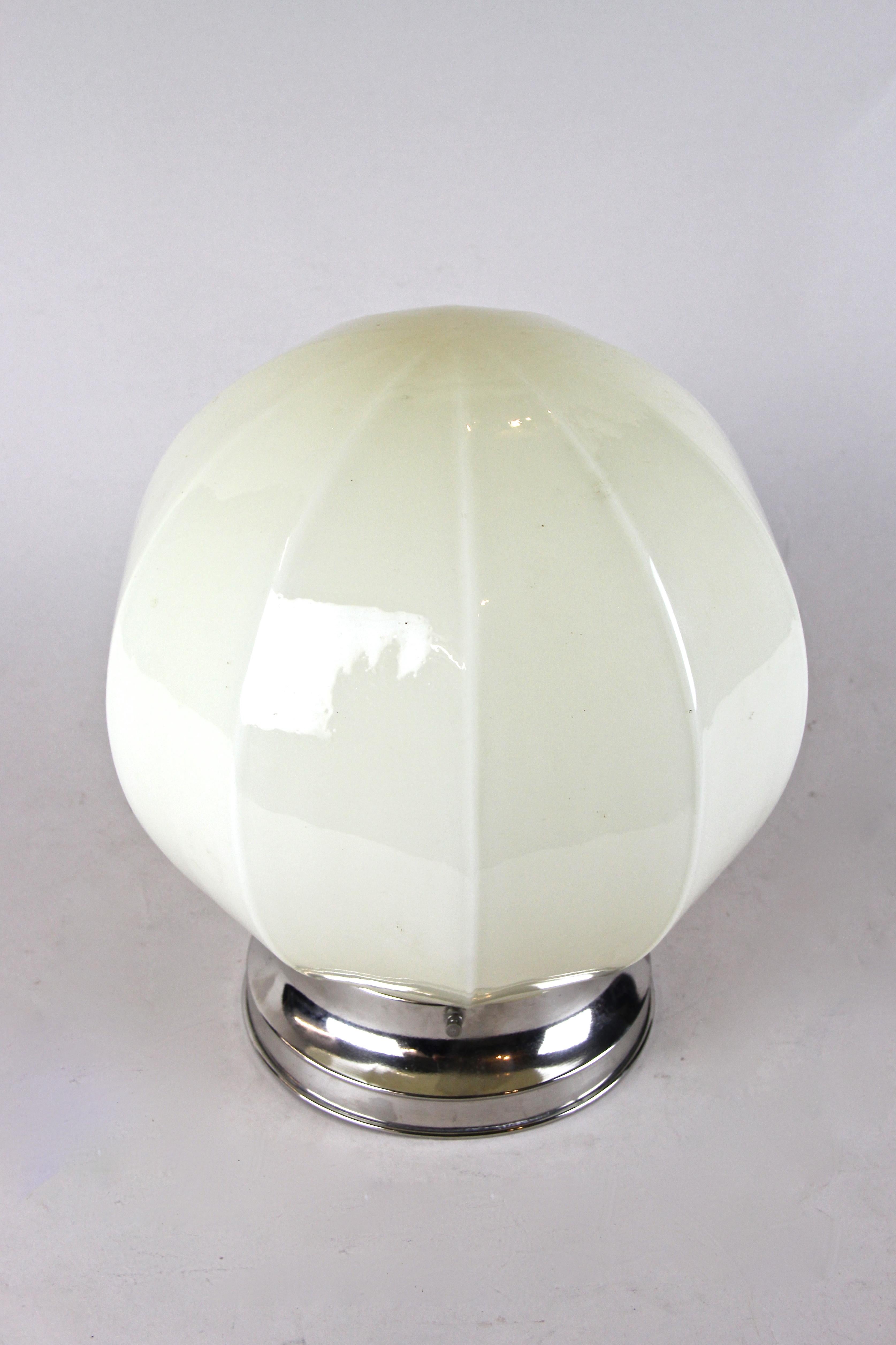 Decorative Art Deco flush mount lightning from the period circa 1930 in Austria.
A nice designed glass ball sits on a chromed metal base and gives this timeless piece of lightning a very own and luxury touch.