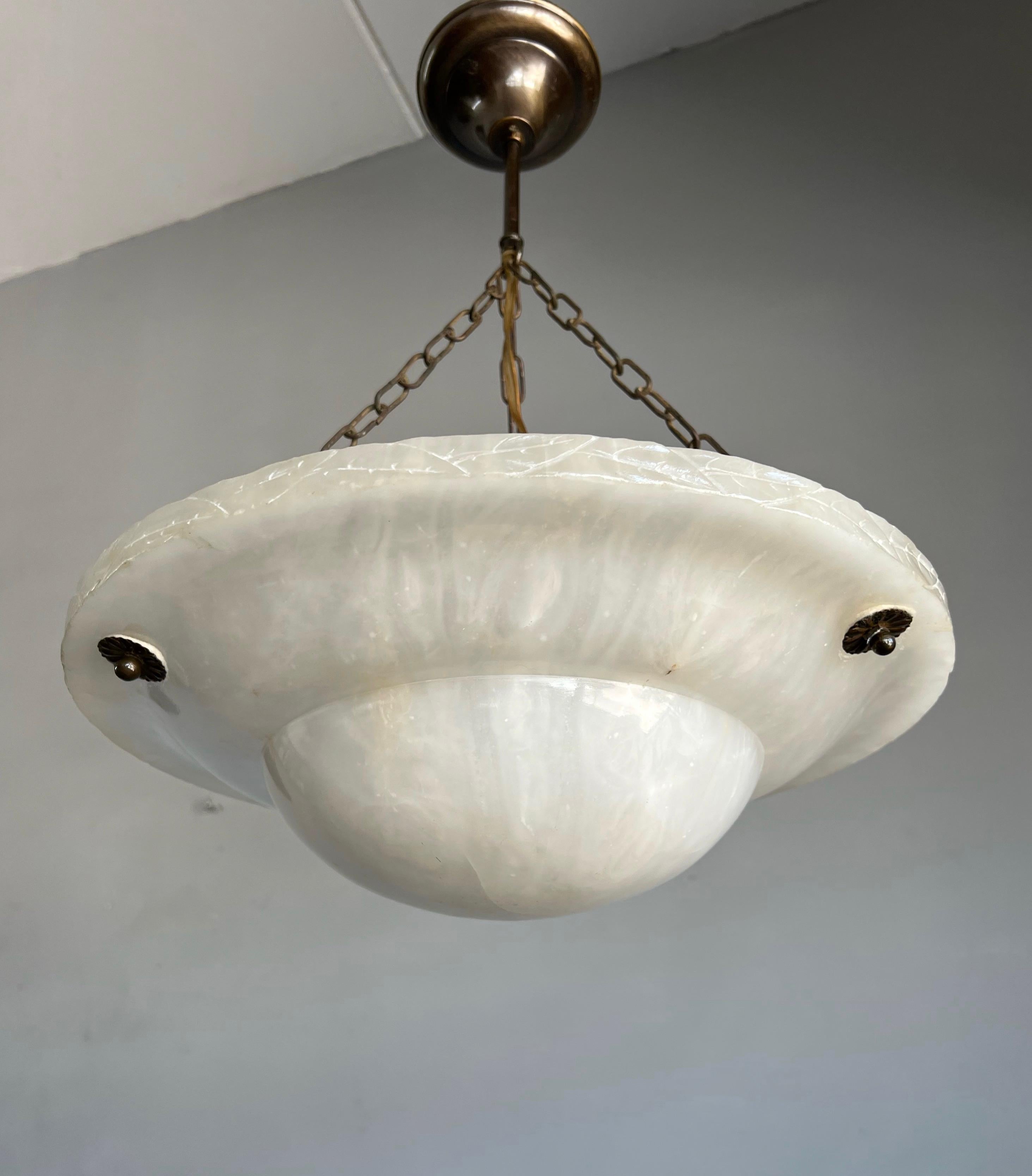 Good size and good condition alabaster pendant from the heydays of the Art Deco era.

This rare shape and ideal size Art Deco light fixture comes with a stunning and mint condition, hand carved and polished alabaster shade. This practical size and