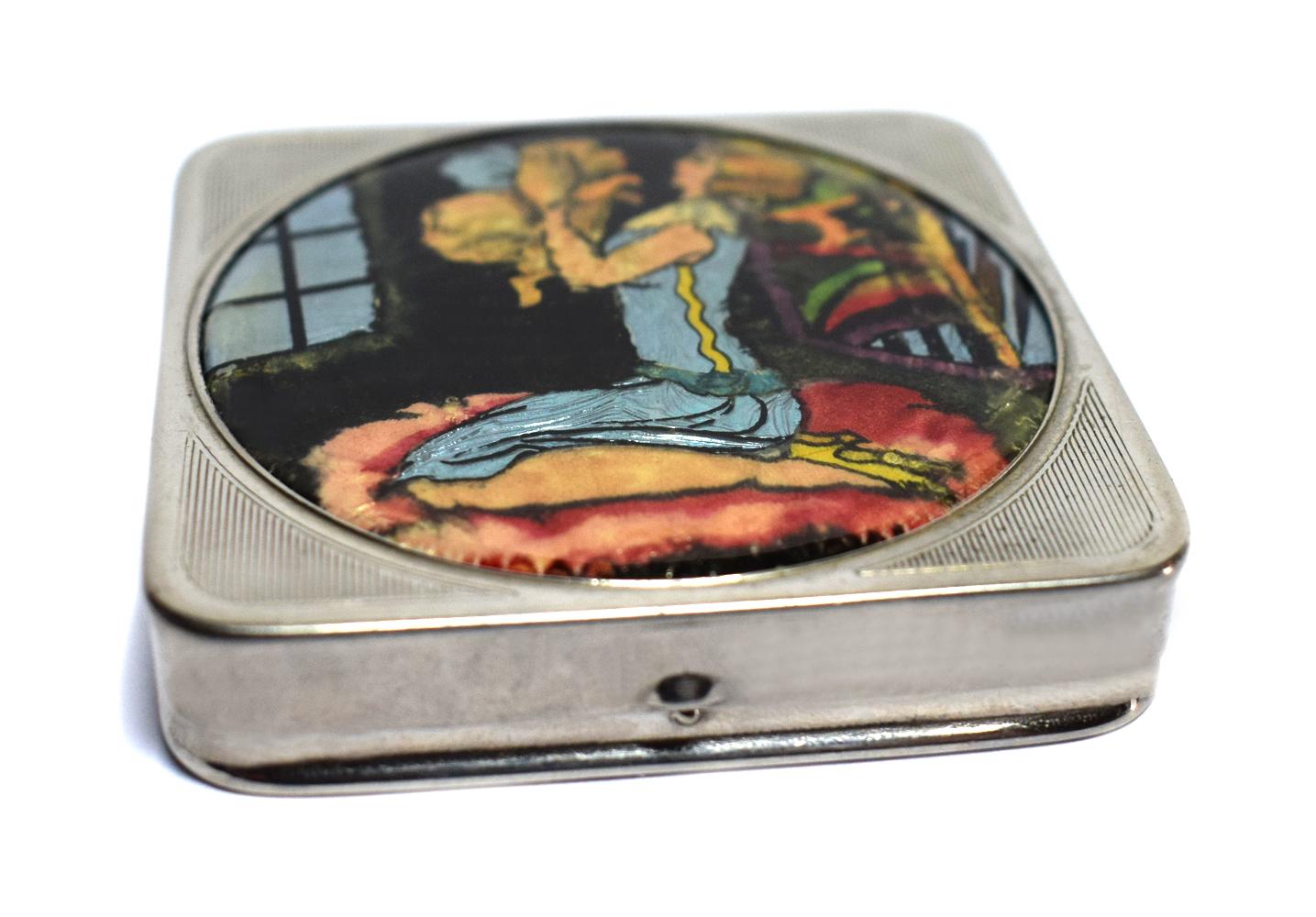 A delightful ladies Art Deco compact marked to the interior with the trade name Stratnoid made in England with the registration design number for 1931. The base is engine turned with the top lid depicting a wonderful scene of a young flapper girl
