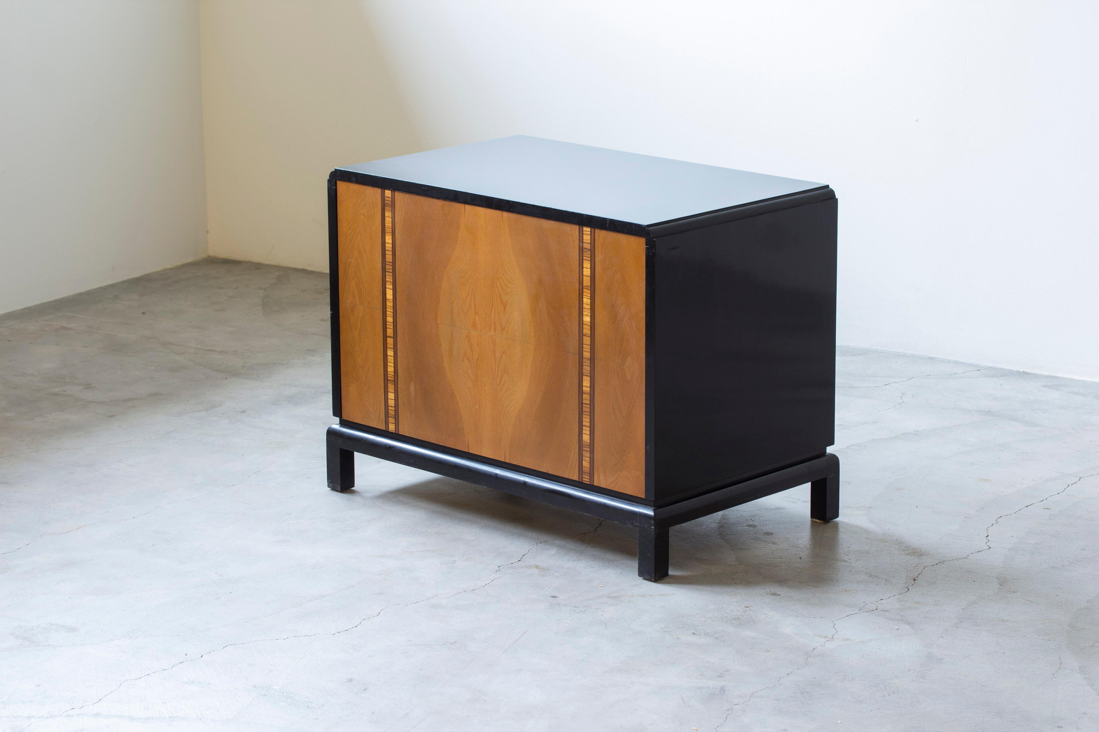 Bar cube by unknown Swedish designer and maker. High quality crafts piece with beautiful attention to details and color. Black lacquered birch and elm wood with geometrical inlays on the door in teak and zebrano. The bar unfolds in various ways