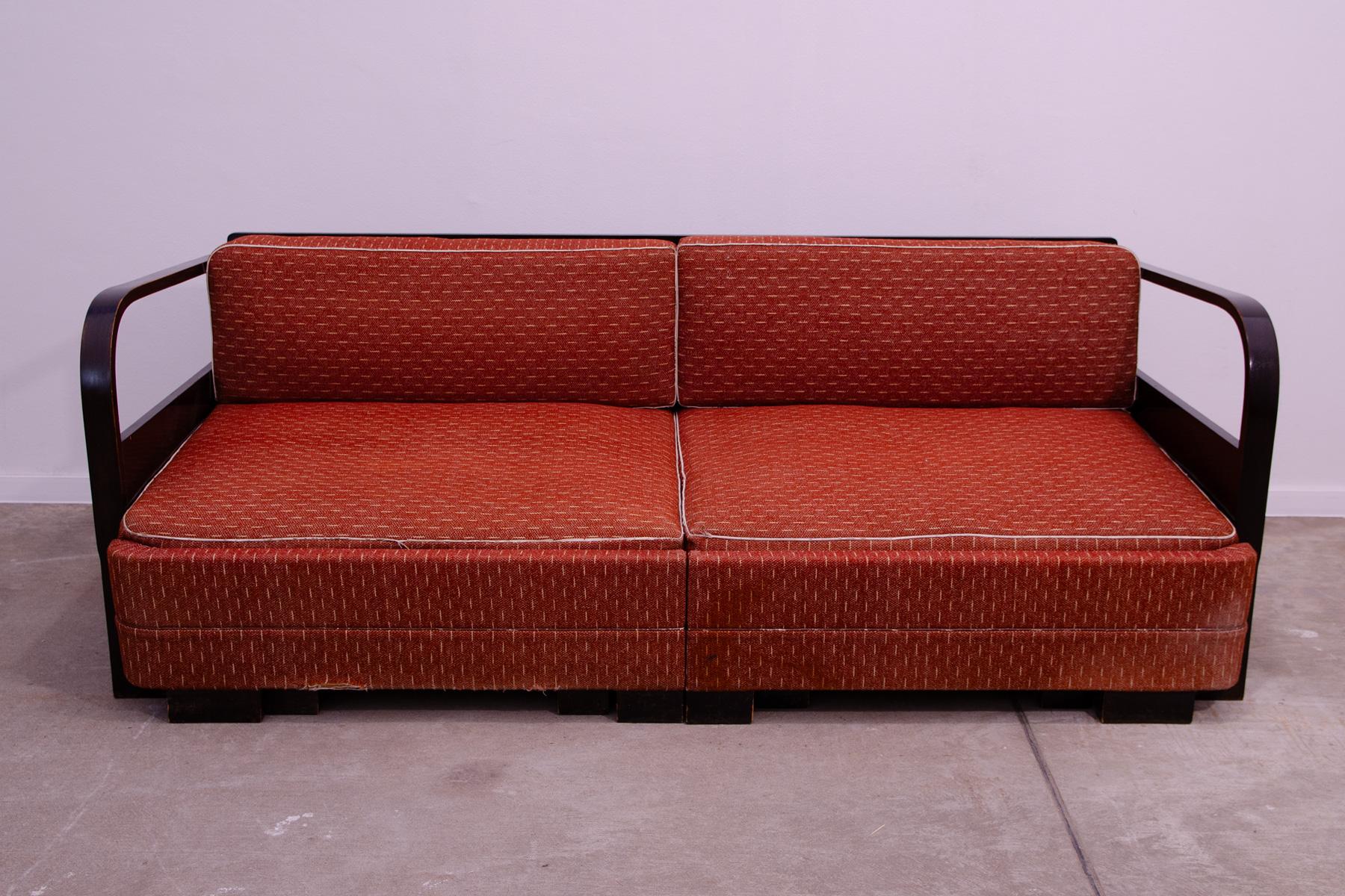 ART DECO style sofa, simple design fits into the context of the design creation in Czechoslovakia between 1930´s-1950´s. Dark stained beech wood. Traces of wear and tear commensurate with age. In good vintage condition. It´s possible to assemble a