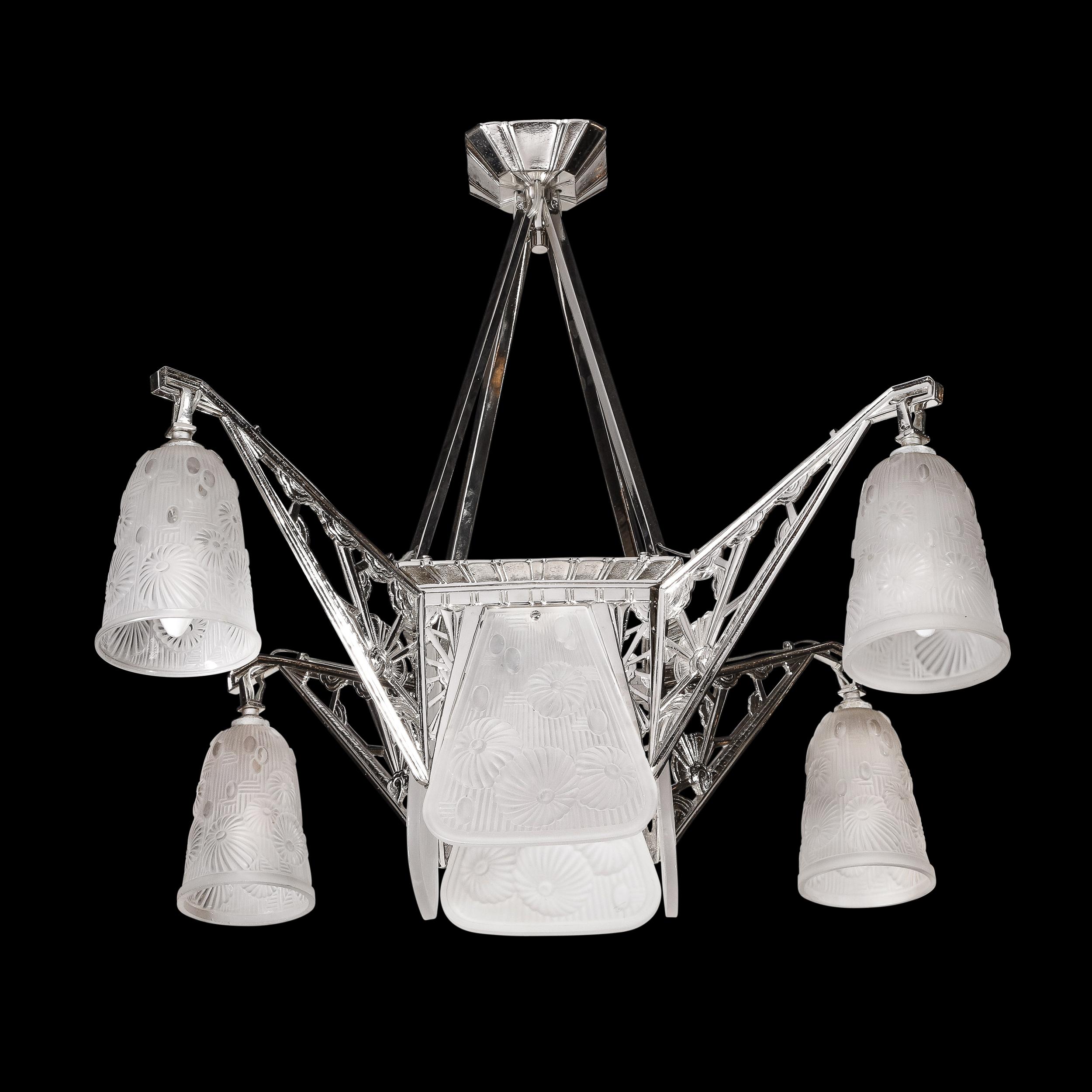 With graceful lines and geometric detailing, this spectacular chandelier is a stunning example of the Art Deco style. Designed by renowned glassmaker Daum in Nancy, France circa 1930, this light fixture features four frosted panels of glass