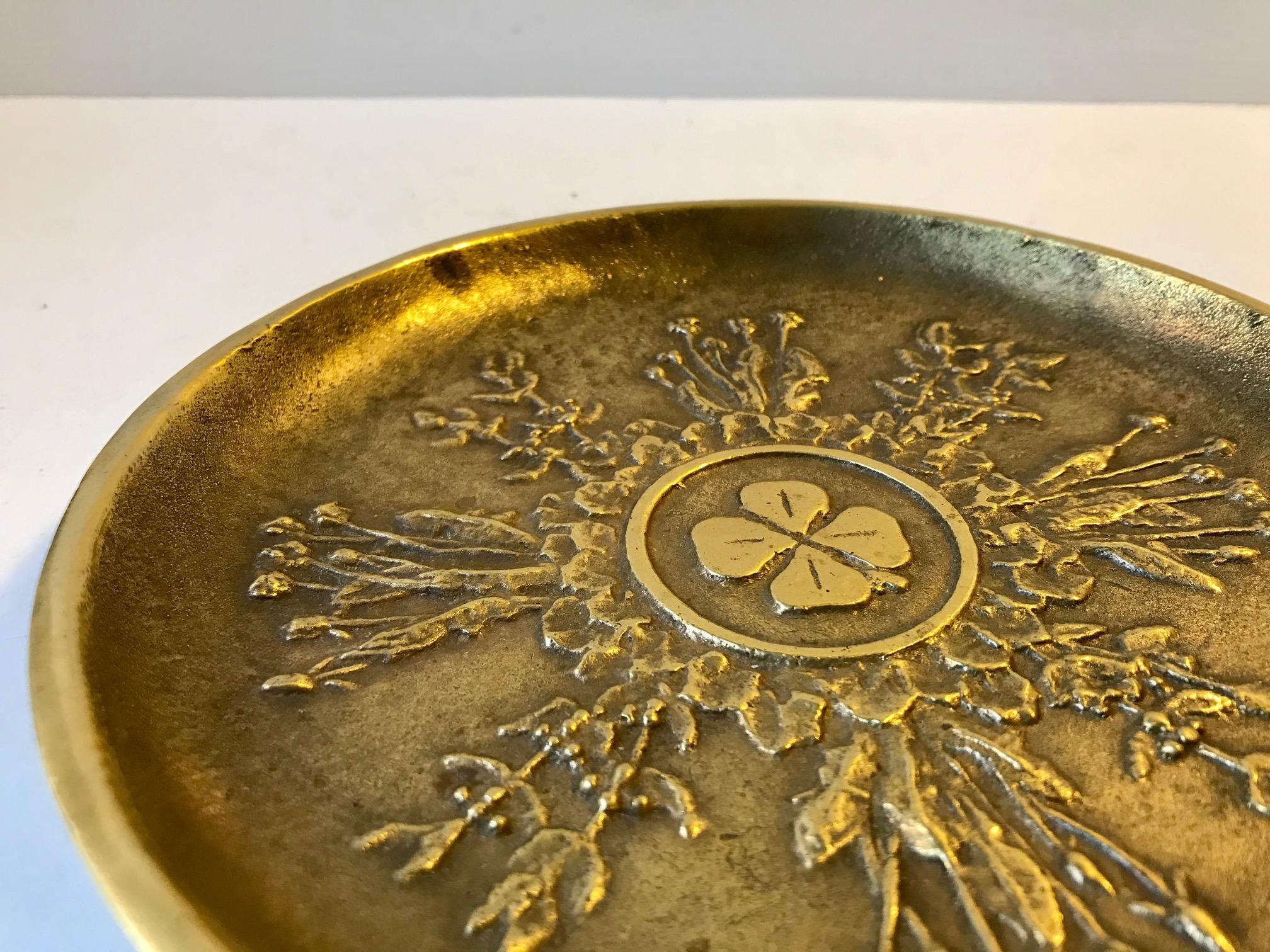 Art Deco bronze bowl or small charger with four clover motif surrounded by floral decorations - all in relief. It is designed by Danish Christian Hansen and manufactured in his metal workshop in Denmark during the 1930s. The same period Just