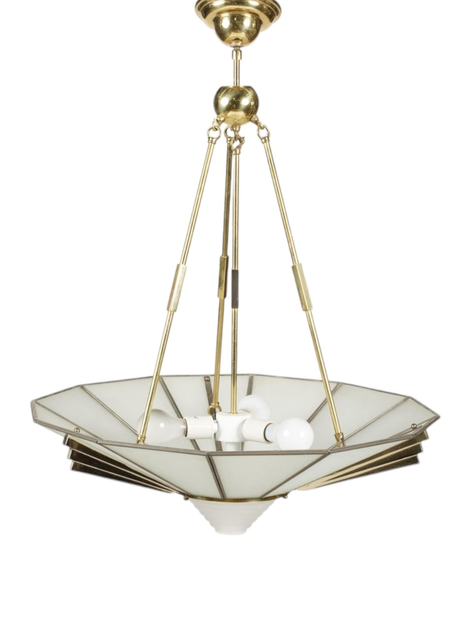 Illuminate your space with the timeless elegance of the Art Deco Frederick Ramond Chandelier. This stunning piece embodies the bold geometric lines and luxurious materials characteristic of the Art Deco movement, blending vintage sophistication with