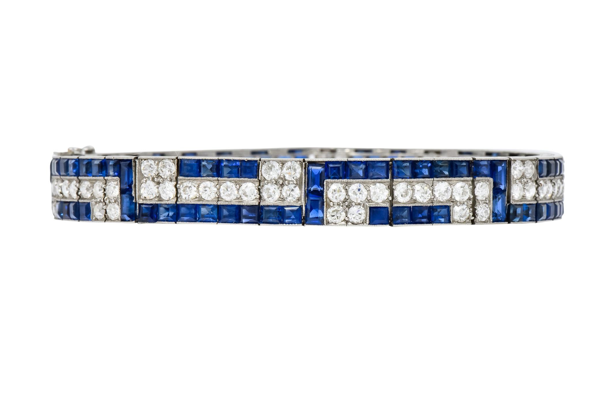 With step cut sapphires, weighing approximately 12.15 carats total, bright royal blue and very well matched

Accented by old European cut diamonds weighing approximately 4.80 carats total, H/I color and VS to SI clarity 

With a geometric motif with