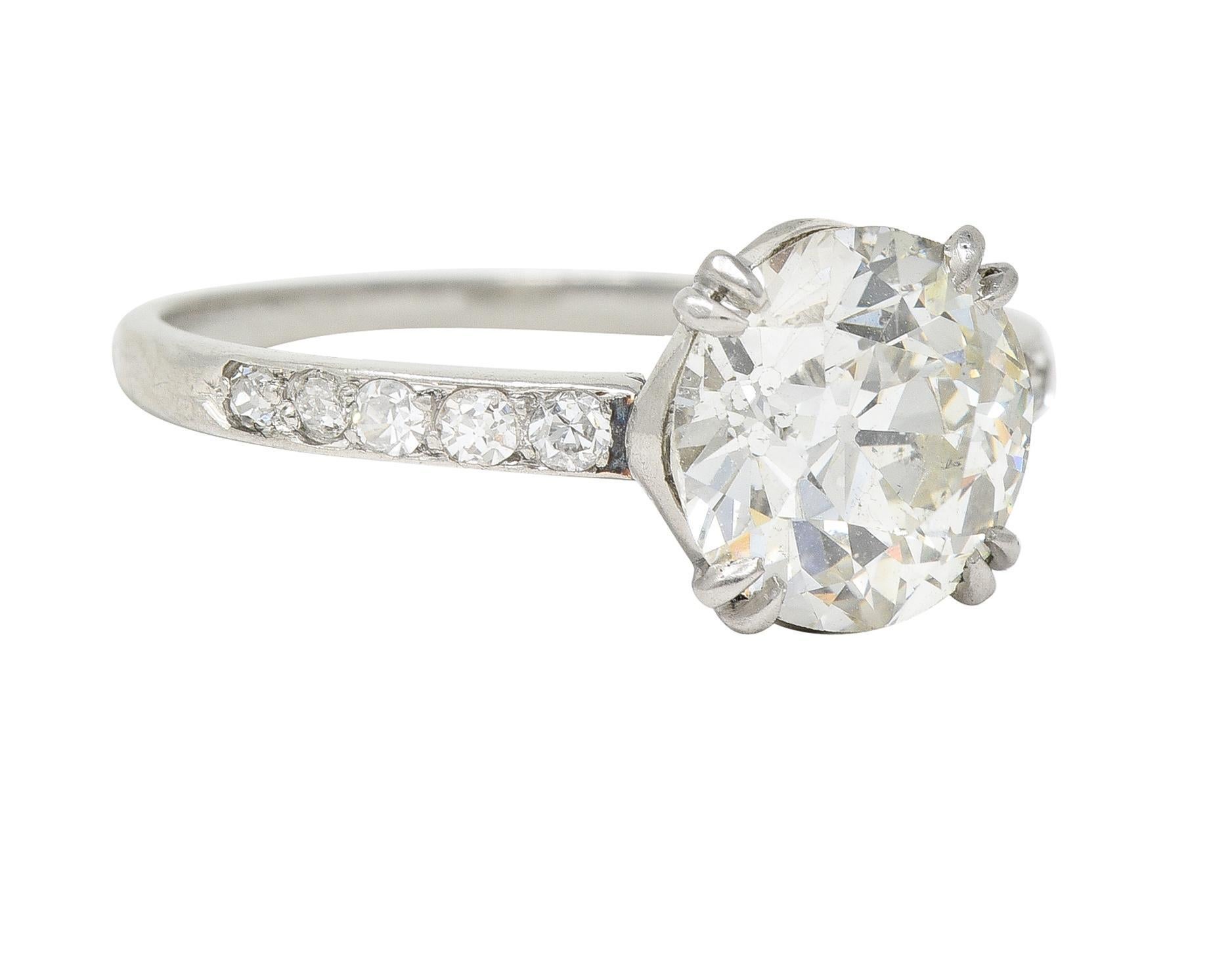 Centering an old European cut diamond weighing 1.96 carats - J color with SI2 clarity
Set with split talon prongs in a basket and flanked by single-cut diamonds 
Bead set in rows and weighing approximately 0.25 carat total
Eye clean and bright