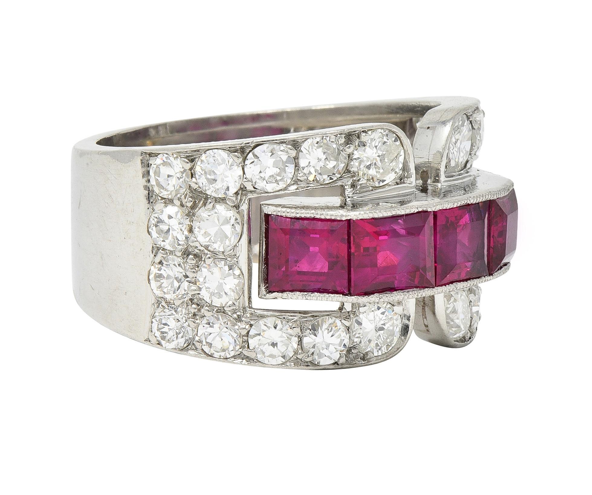 Centering an east to west row of channel set step-cut rubies weighing approximately 3.40 carats
Transparent medium purplish red in color - accented by milgrain edges
Flanked by buckle motif shoulders bead set with transitional cut diamonds
Weighing