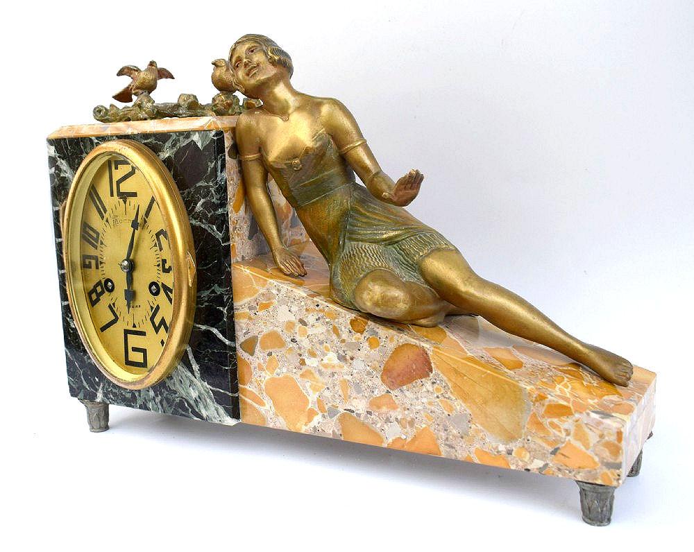 For your consideration is this very charming Art Deco 8 day clock, originating from France and dating to the late 20's early 30's. The tri coloured marble casing is supported on four spelter legs and is an unusual and very appealing shape. The gold