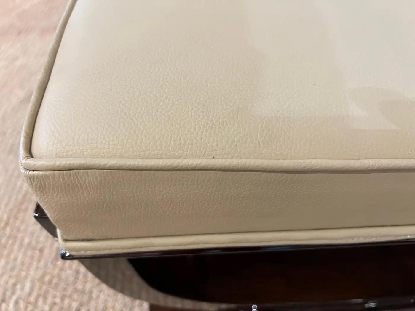 Bench is made out of walnut wood, comfortable seat is re-upholstered with beige leather. Bench is supported by two curved wooden legs that are connected with trapezoid shape base.

Condition is very good, restored
France, c. 1930s
Measures: 45” W x
