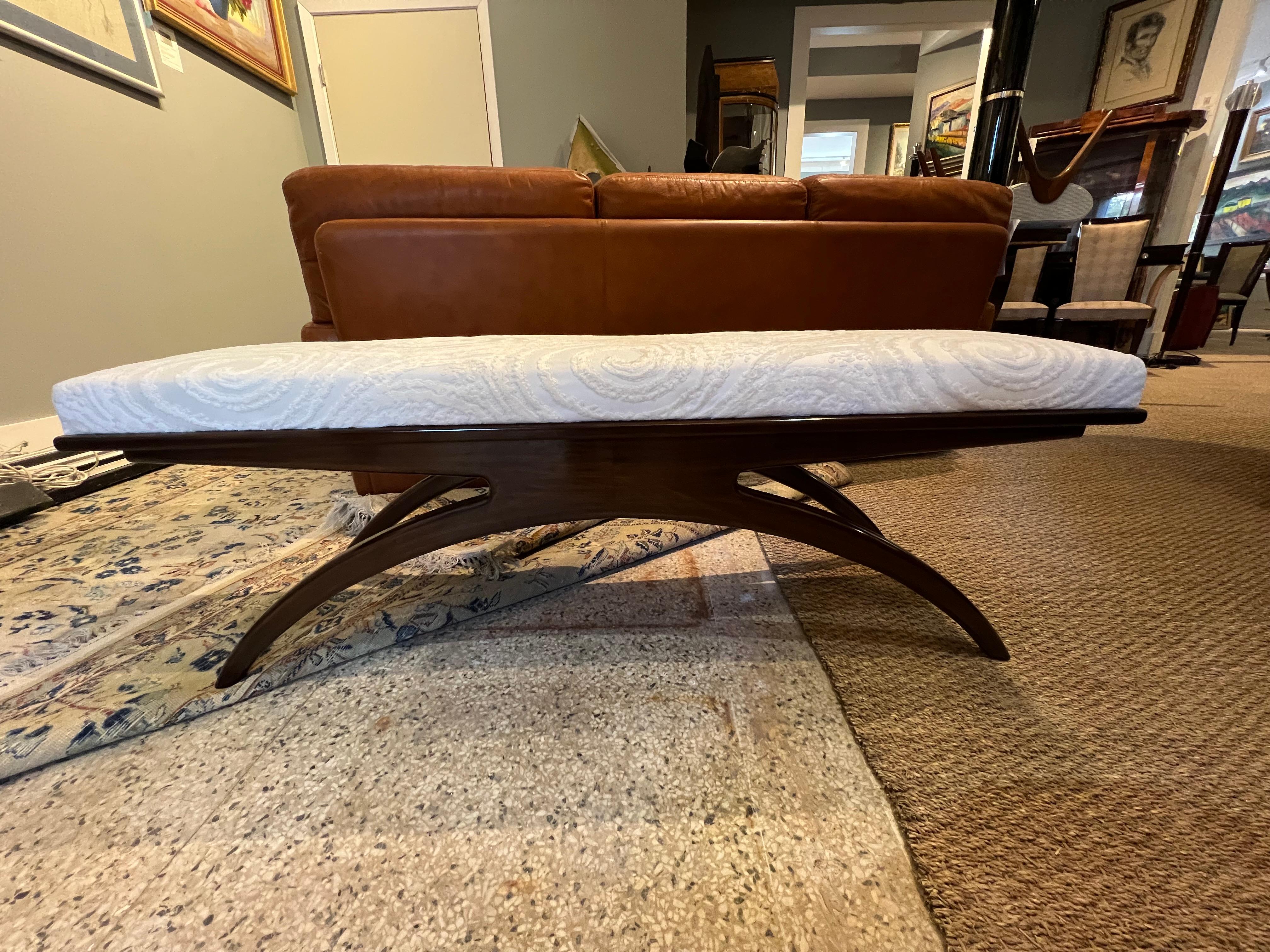 Art Deco bench is made out of walnut wood. Seat is newly re-upholstered in a light grey fabric with circular design. It supported and elevated by the 4 semi-curved legs, where 2 legs on each side are connected with each other, creating crescent