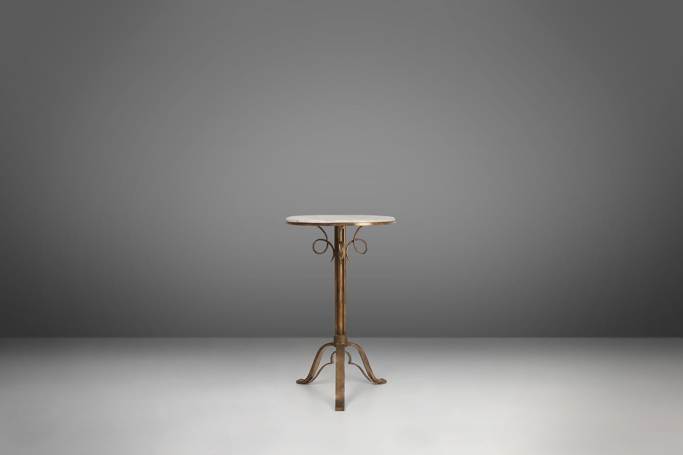Sophisticated Art Deco Bistro Table with carrara marble top and timeless elegant brass stand. Designed in the 1930s in France, this stunning piece showcases the perfect fusion of luxurious materials and impeccable craftsmanship. The table features a