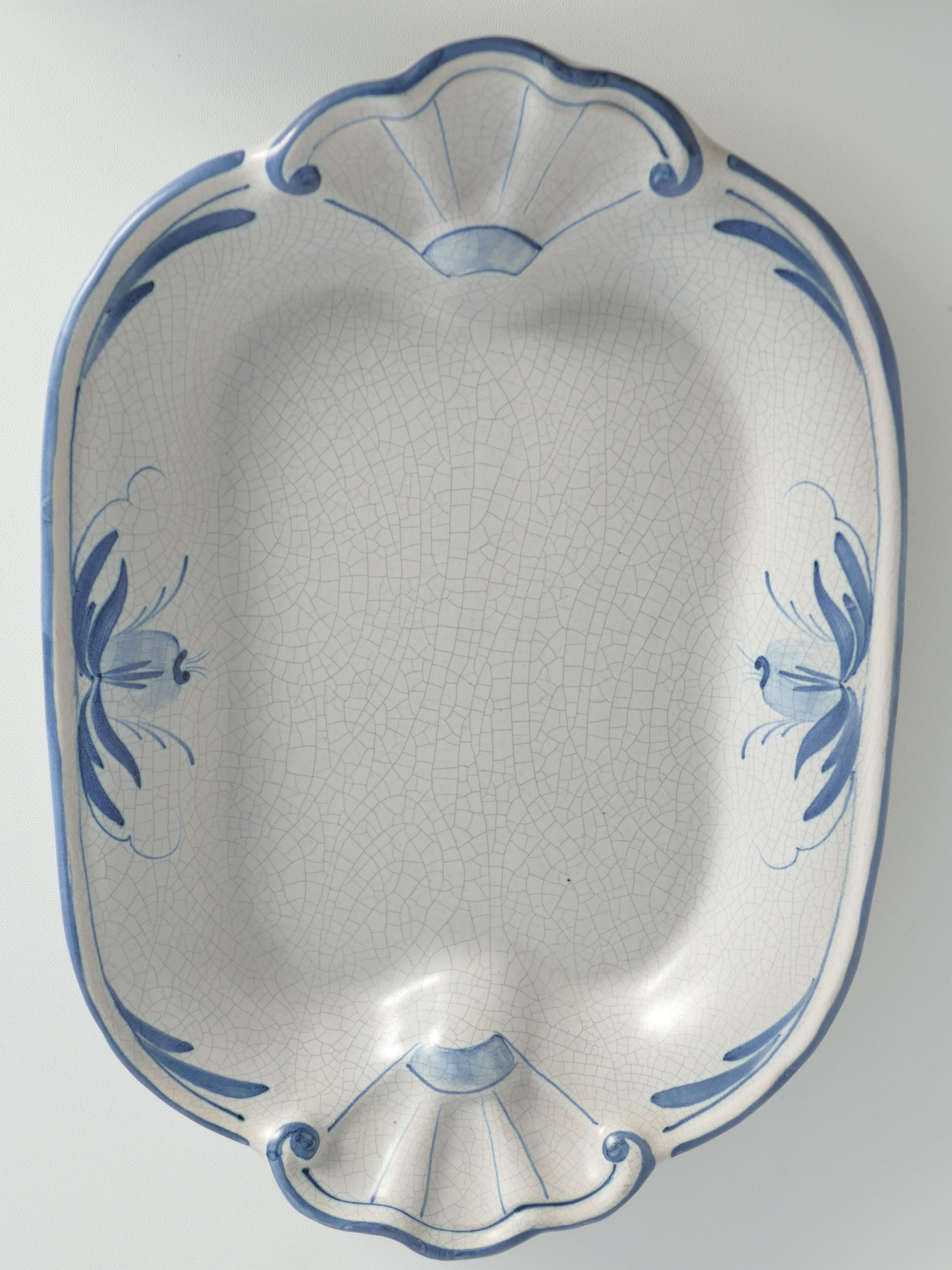 This delightful plate designed by Allan Ebeling for Bo Fajans, exudes both functionality and whimsy. Its french blue hue adorned with a delicate blue floral decor adds a touch of elegance to any setting. 

Identified by the Bo Fajans number 1539,