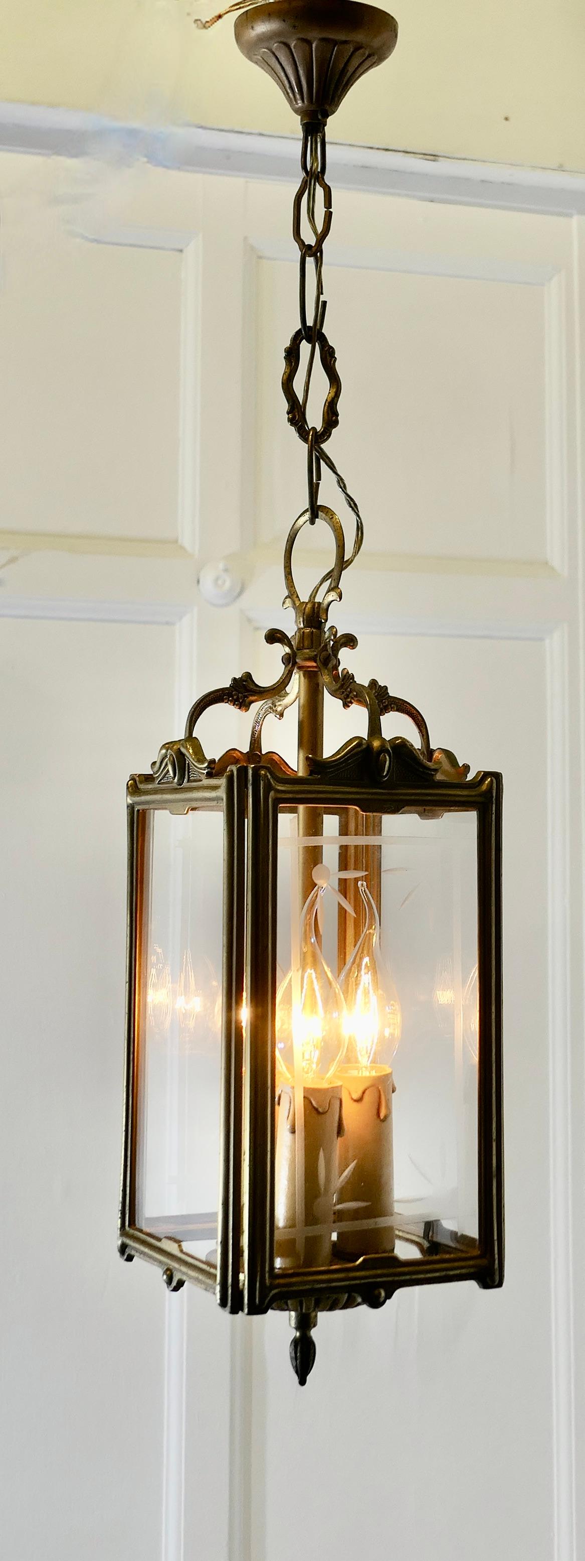  Art Deco French Brass and Etched Glass Lantern 

This lovely light has 4 flat glass panels some of which still have the original etching, 
The lantern has a 3 candle sconce which gives a very bright light when lit
The lantern frame is old dark
