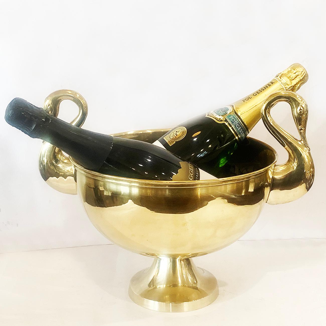 Absolutely spectacular Art Deco large, polished French brass Rafraichissoir, or bronze champagne Bucket, with finely detailed Swan heads as handles.. Will easily hold up to 3 Champagne bottles, a soft age patina to the interion and spotless to the