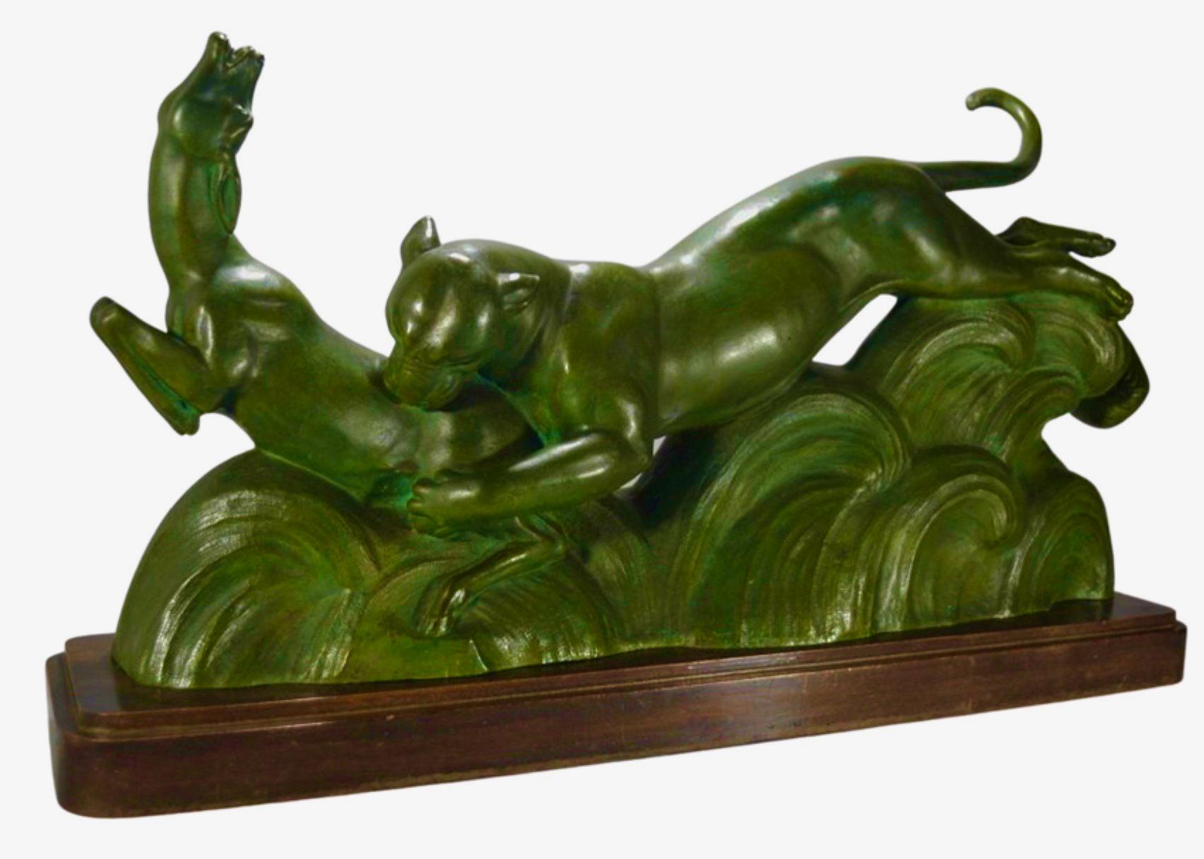 Art Deco French bronze sculpture of panther and gazelle by Alexander Ouline portrays animals in action, a kind of abstract forest floor in bronze all mounted on a wooden base. Ouline was a Belgian artist, working in France from 1918- 1940, famous