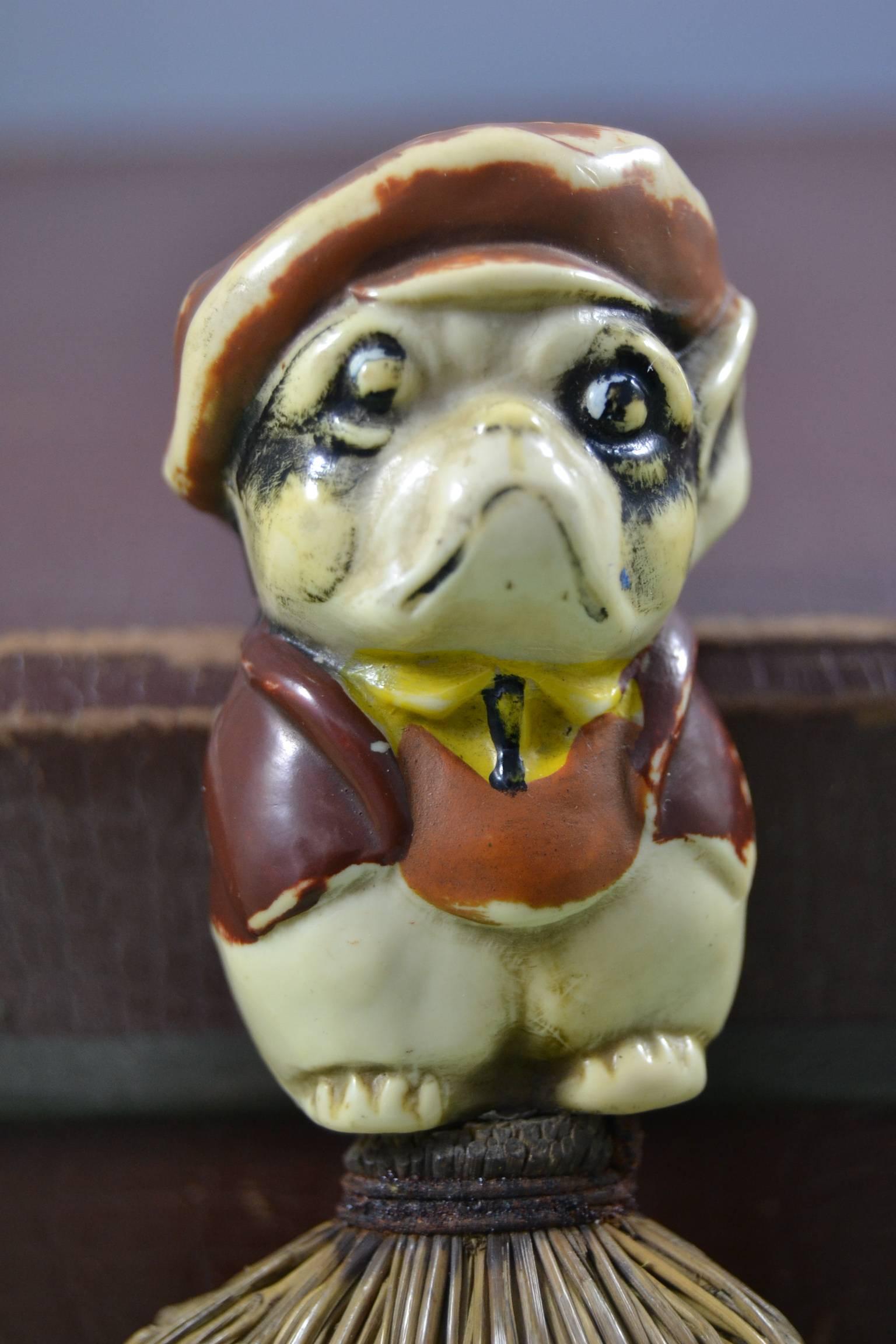 Antique hand brush with a Bulldog dog on top. Art Nouveau, Art Deco figural hand brush
This figural mini broom, table broom wears a cartoon, comical bulldog character. He wears a hat, a jacket and pants and is made of solid celluloid and