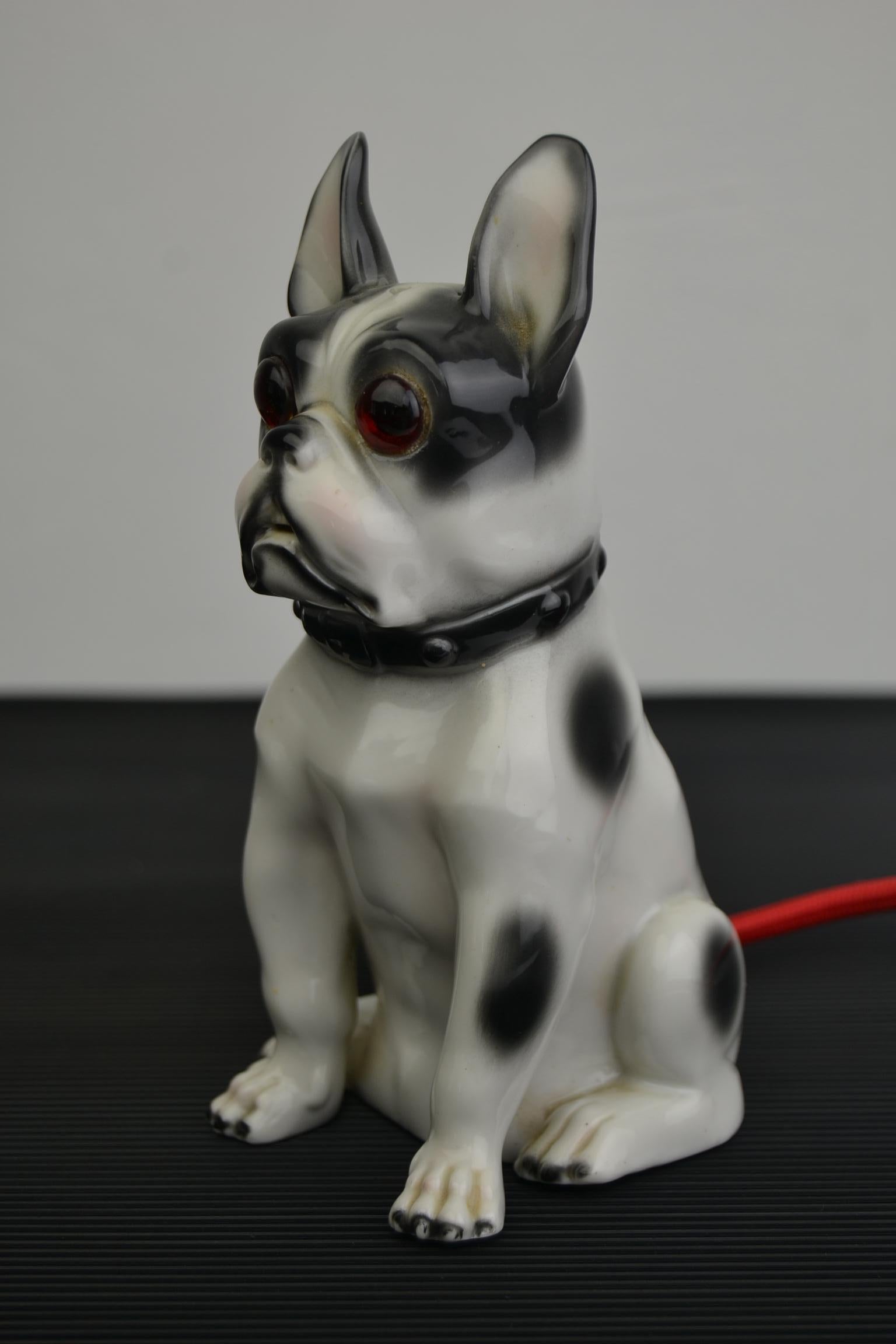 Art Deco porcelain perfume light in the shape of a French bulldog dog.
This dog figurine has big glass eyes and dates circa 1930s-1940s.
He wears a number on the base and comes probably from Germany.
When the light is on, he looks adorable.