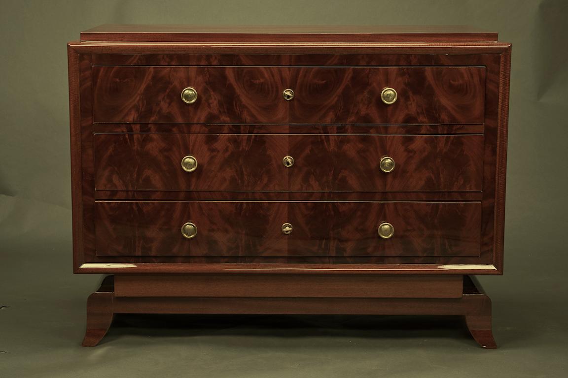Commode has 3 large keyed drawers. Each drawer has 2 round handles. It is elevated by 4 elongated semi-circular legs. 
Condition is perfect. Restored.

French, circa 1930s.

Measures: 45” W x 20” D x 33” H.
 