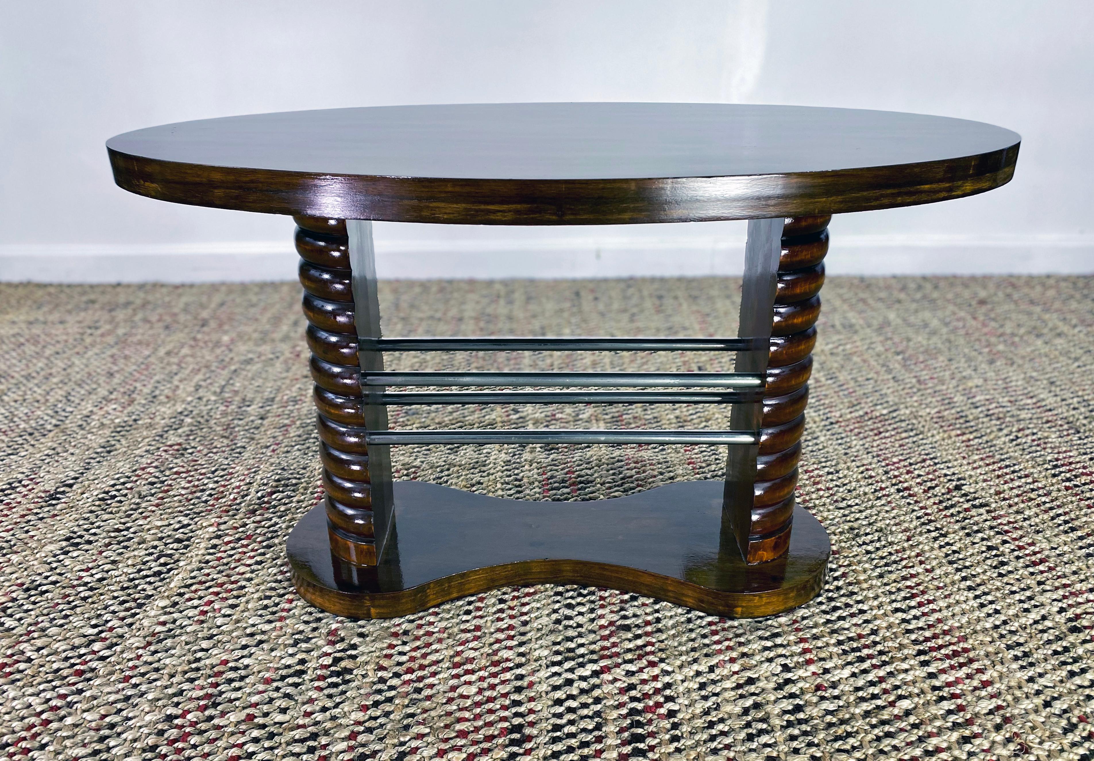 1930s Art Deco French coffee table. This mahogany top guéridon is mounted on two demilune solid wood carved columns joined by 4 chrome bars. The side table is fully restored. In perfect condition. France, circa 1930.
Measurement:
Oval top 39