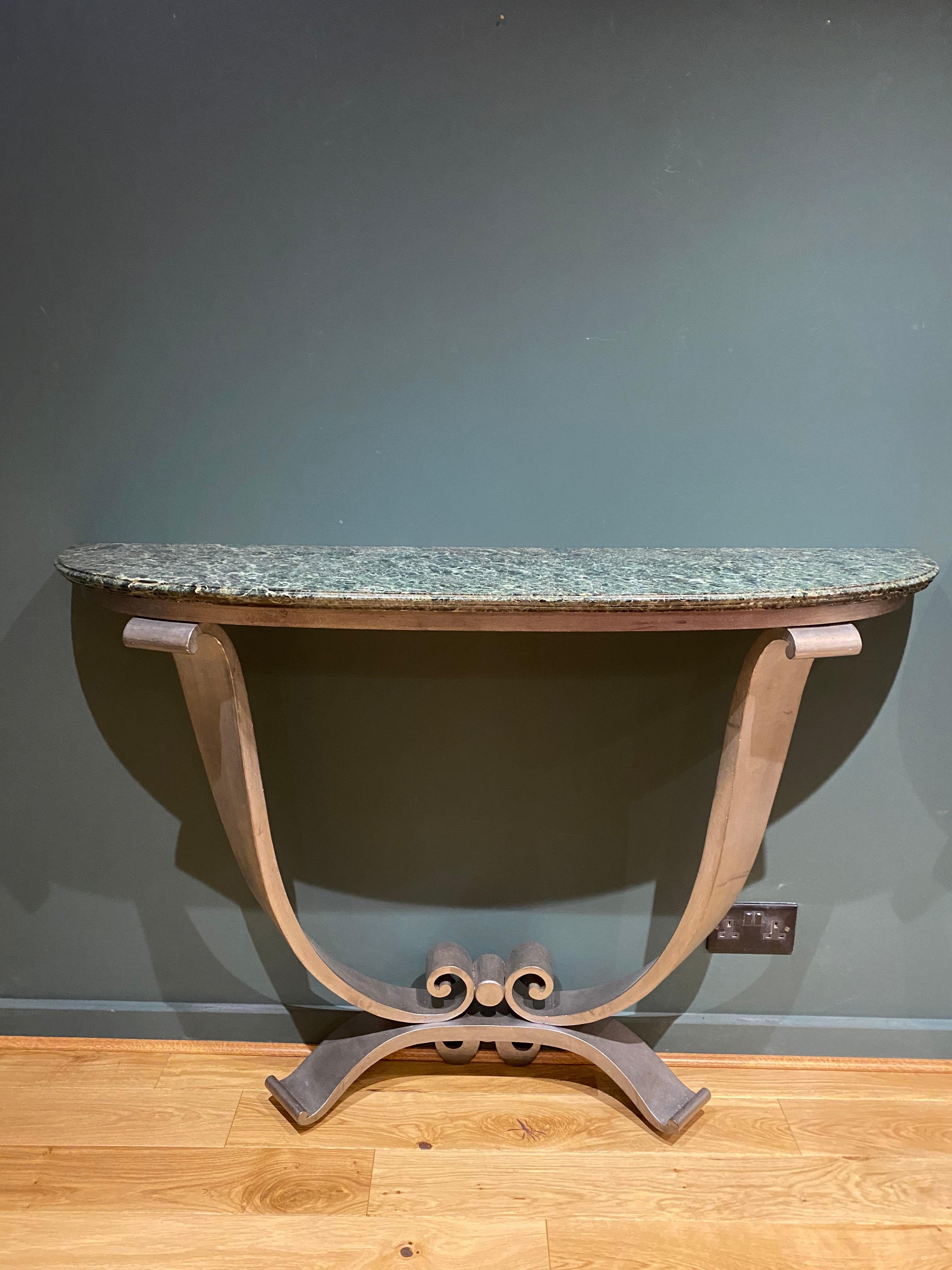 A rare pair of French Art Deco brushed steel & marble top console tables att. to Jules Leleu.

  
  