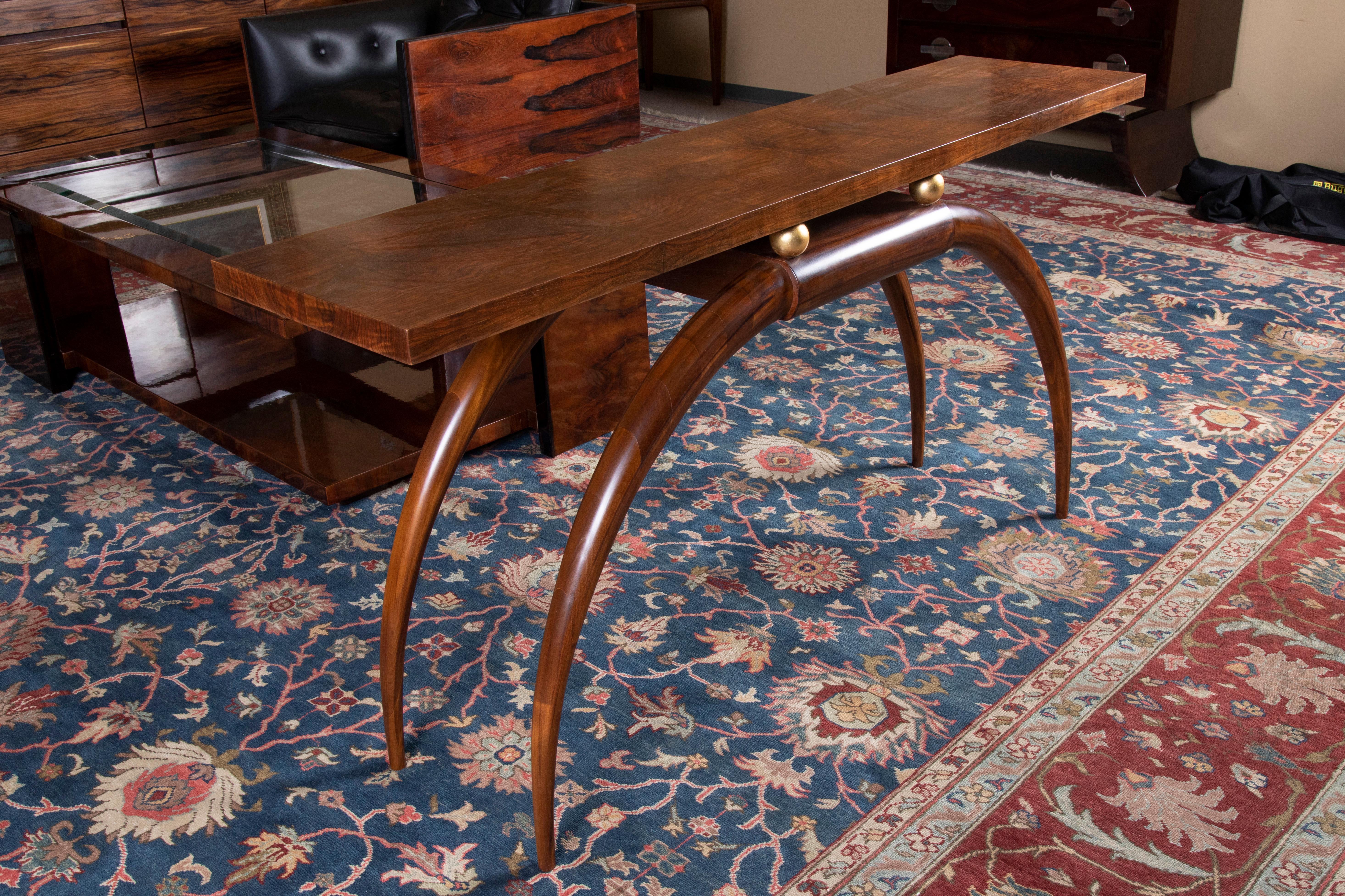  Art Deco French console in walnut

A console is made out of fine quality walnut wood. The wide rectangular top is displaying a beauty of the wood. It is elevated by the 4 curvy thin legs, that are connected between each other under the console top.