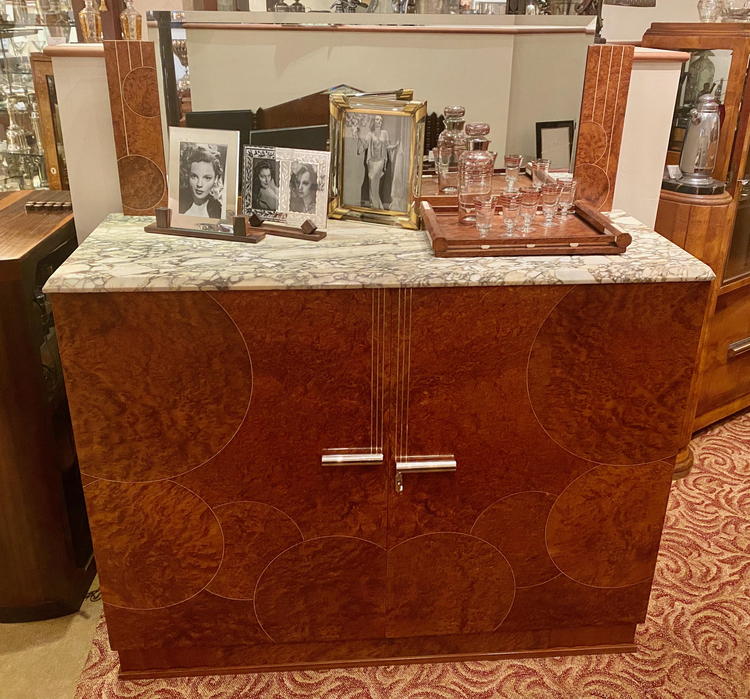 Art Deco French custom buffet of Amboyna burl wood with inlay. This custom book-matched amboyna cabinet of inlaid wood in a bubble motif is accented by a thin piece of metal which encircles each bubble. There is a range of quality details throughout