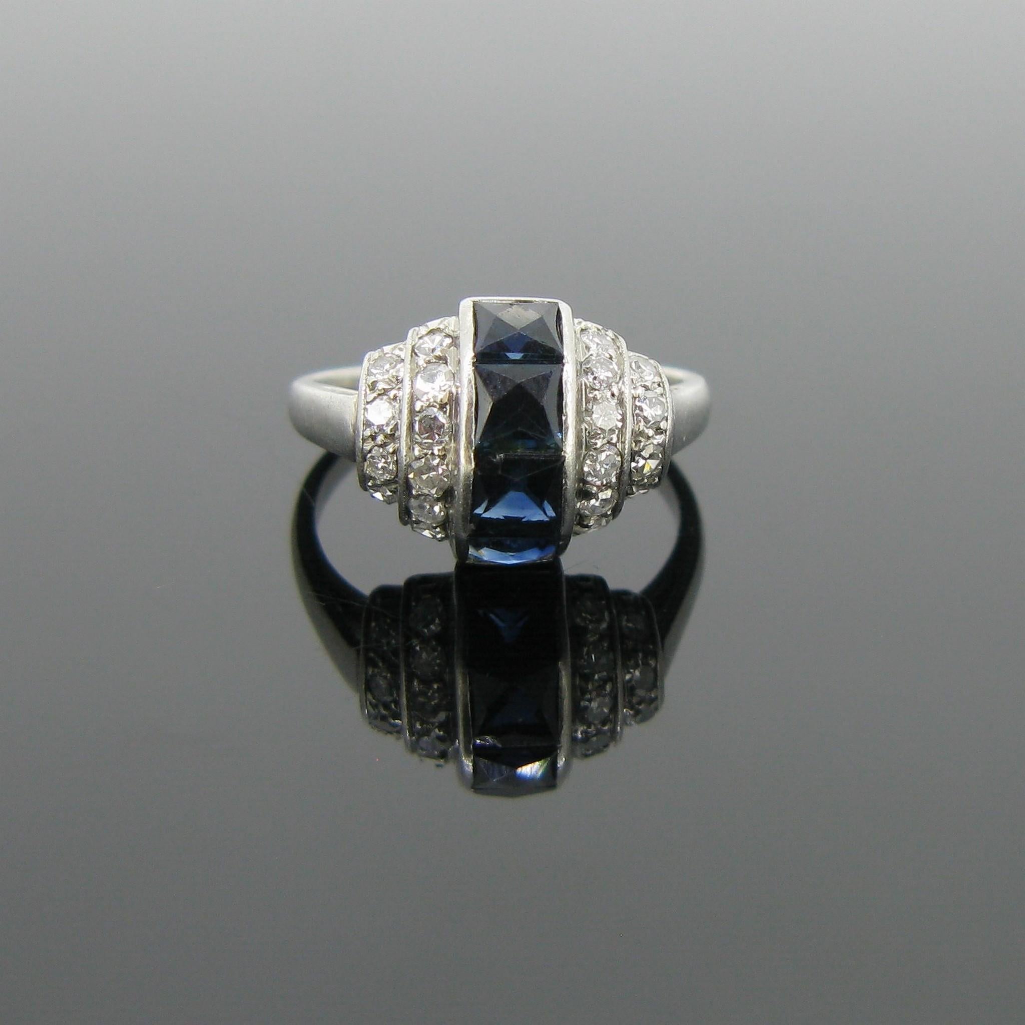 This ring is directly from the Art Deco era. It features 4 French Ct sapphires in the middle row with a total carat weight of at least 1.6ct and is adorned with two rows of single cut diamonds on each side for a total carat weight of 0.60ct. It is