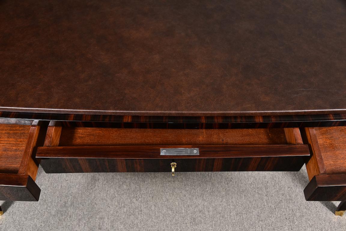 The desk is very comfortable with 3 storage drawers. 2 drawers have wide brass handles and a middle drawer has a key. The top of the desk is decorated with high quality dark brown leather. 4 elongated legs are elevating and supporting desk. Each of