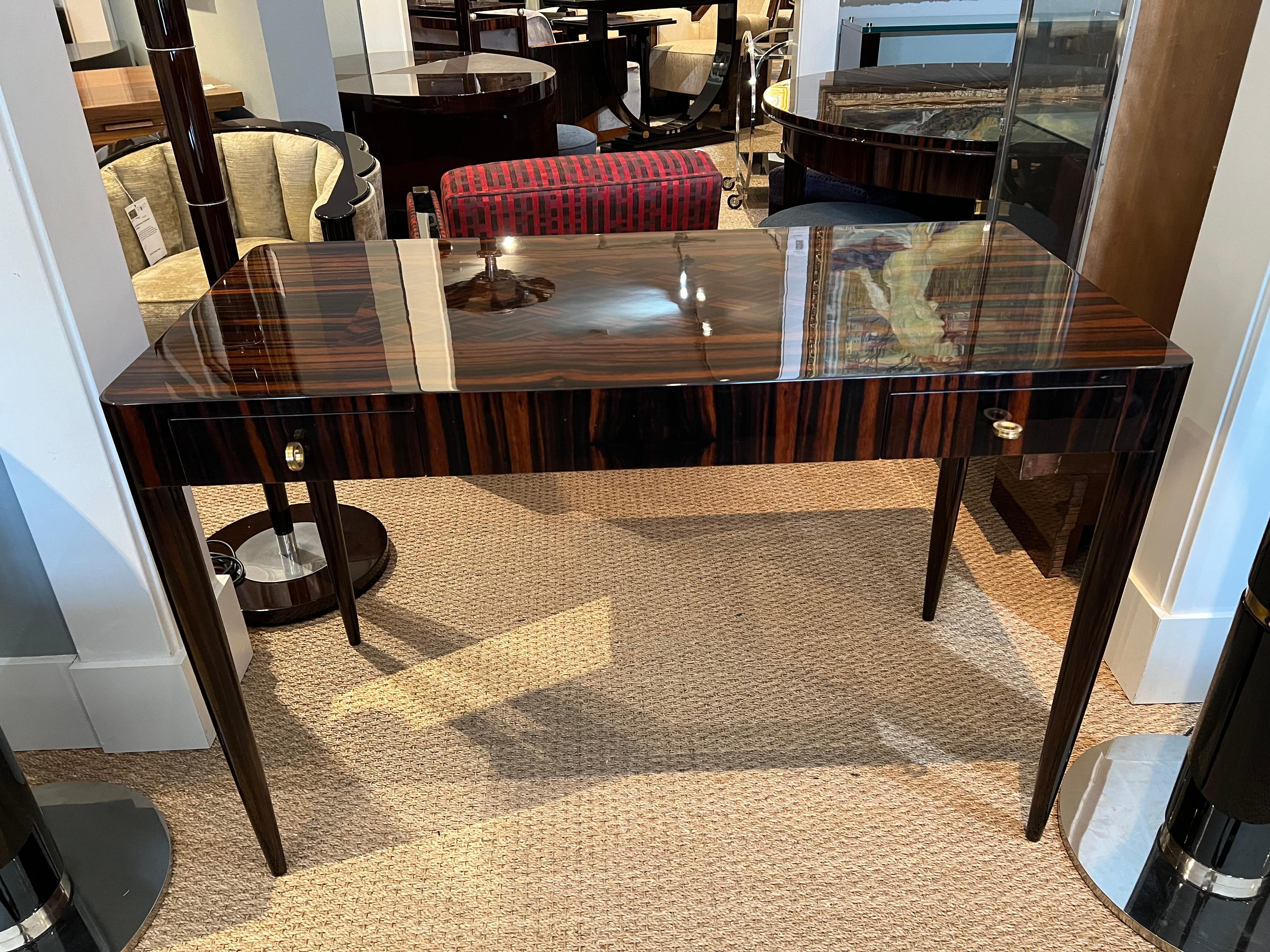 Art Deco French desk with parquet
tabletop in Macassar wood
Desk has a beautiful tabletop with inlaid parquet element. It has rounded corners and 2 keyed drawers upfront. Tabletop is elevated by 4 slim elongated legs.

Condition is