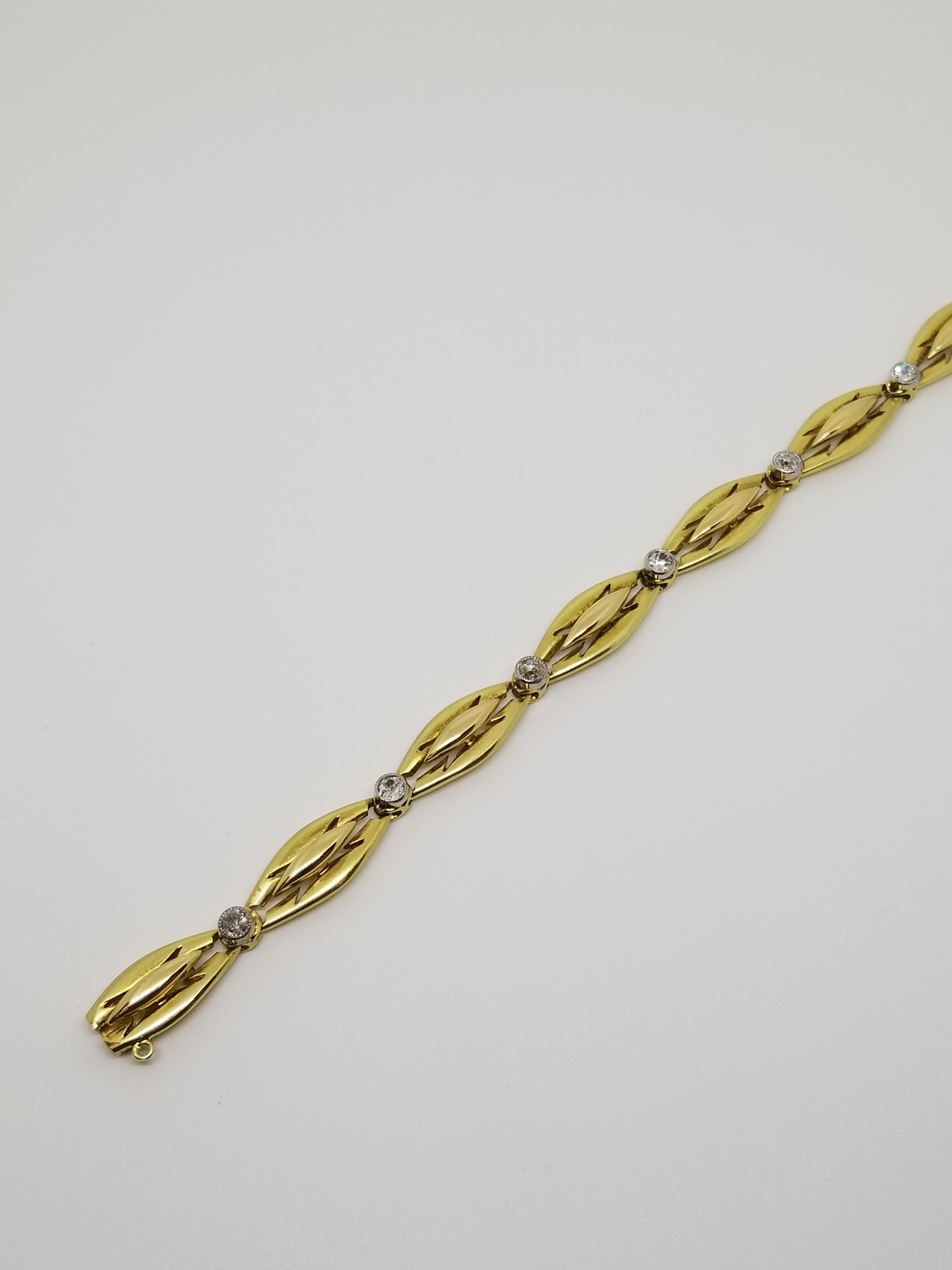An 18 karat yellow gold circle of stylized organic leaf motifs alternating with bezel set shimmering round single cut diamonds, makes this Art Deco French bracelet a one-of-a-kind collectible.  7 1/2