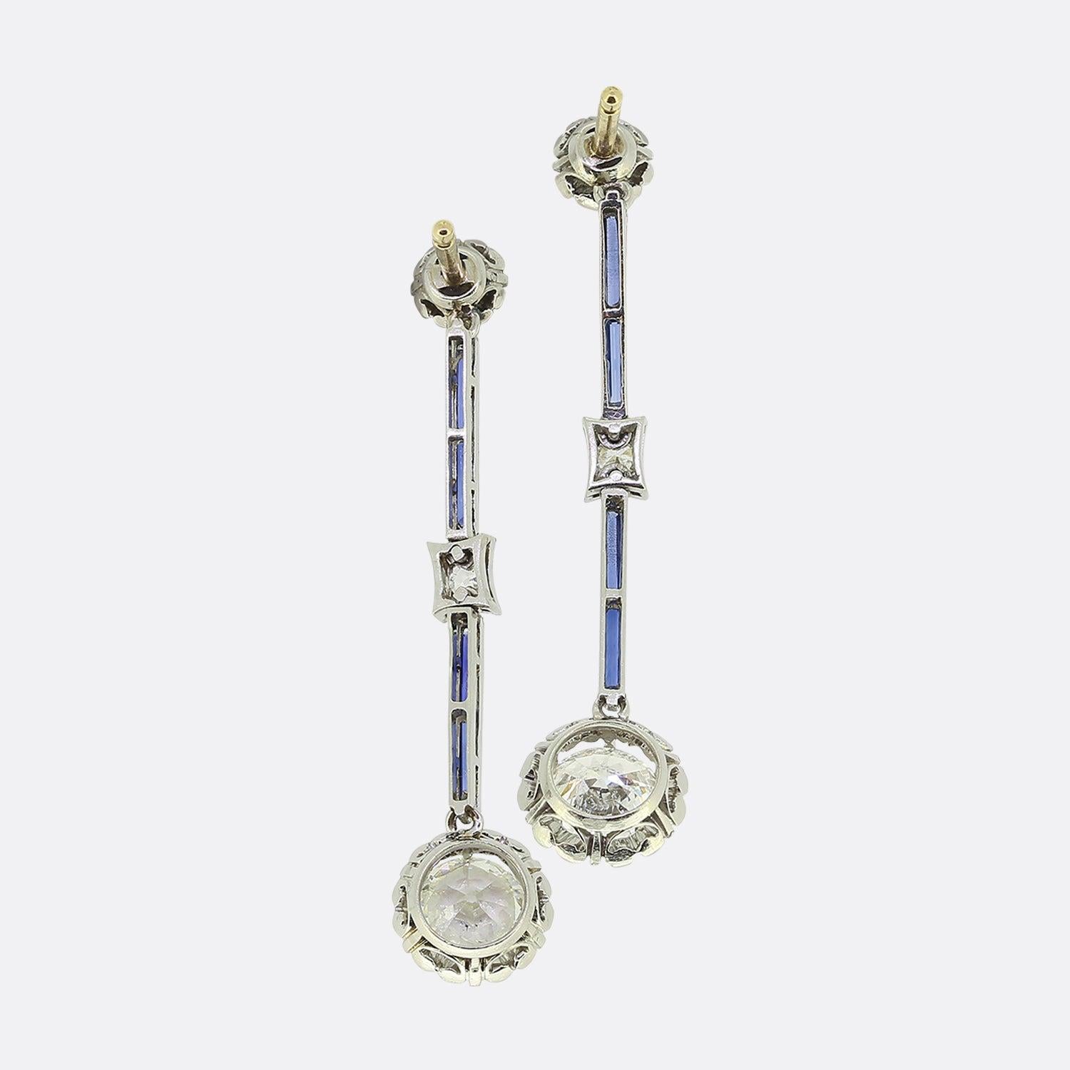 Here we have a wonderful pair of diamond drop earrings, dating back to the Art Deco era. The focal point of each earring is a 0.65 carat old cut diamond that sits at the bottom. Leading down to the principal diamonds there are two rows of