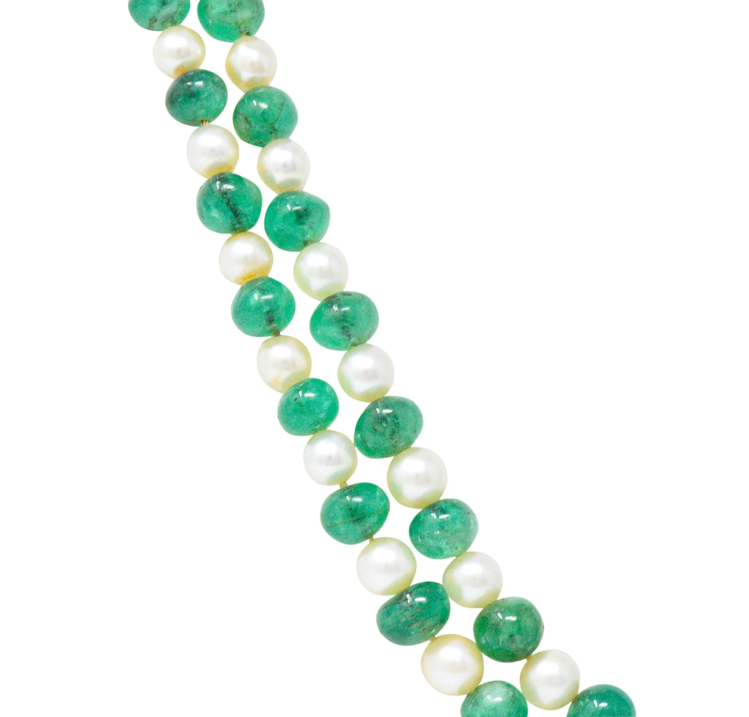 Necklace is comprised of two strands of tumbled emerald beads alternating with round cultured pearls

Emeralds are naturally included and medium-light green in color; measuring approximately 4.1 to 8.0 mm

Cultured pearls measure approximately 2.9